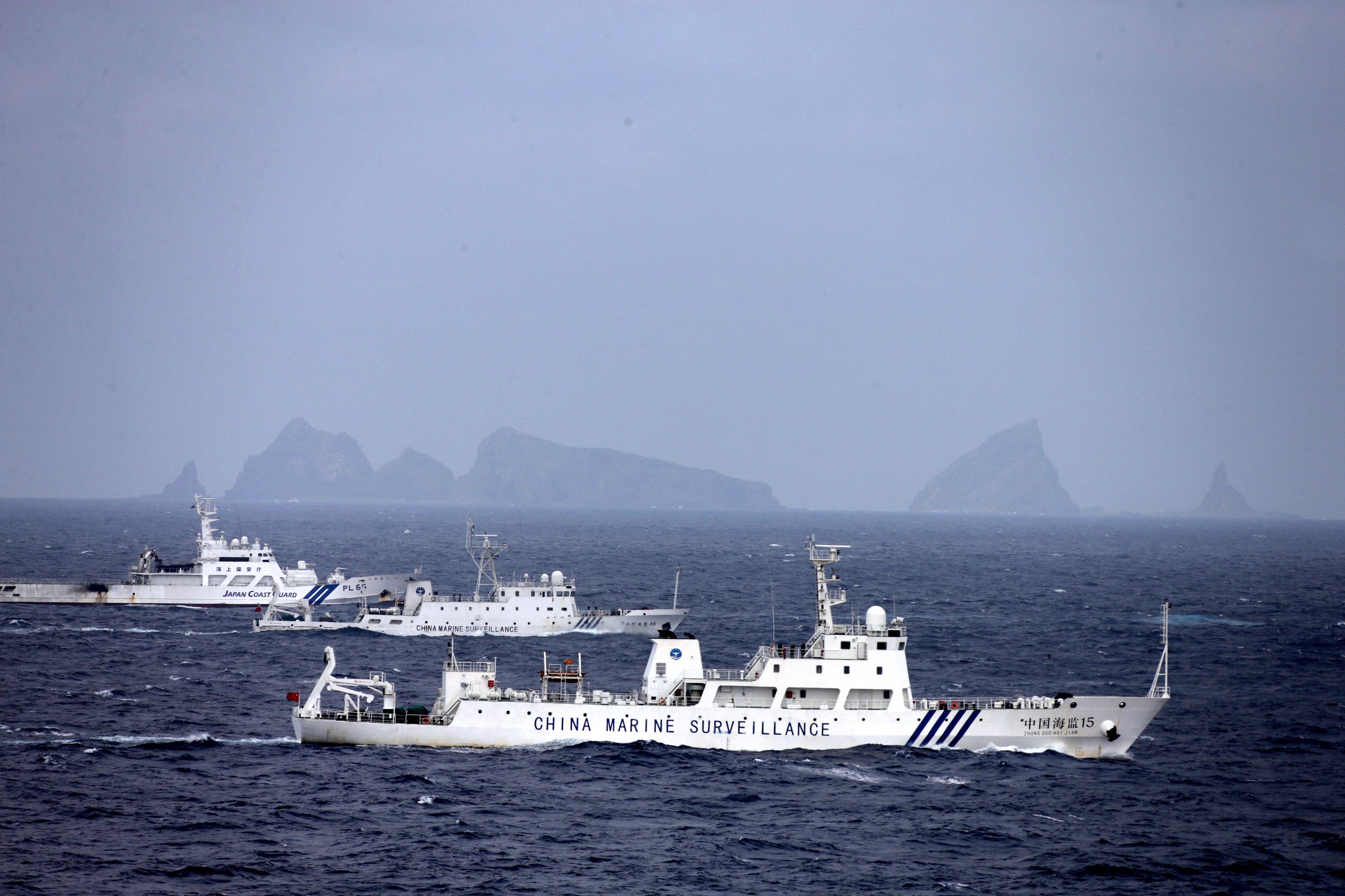 ISHIGAKI, JAPAN - APRIL 23:     In this aerial image, a China Marine Surveillance vessels (front and middle) cruises with a Japan Coast Guard ship near Kita kojima and Minami kojima of the disputed Senkaku Islands on April 23, 2013 in Ishigaki, Okinawa, Japan. 8 Chinese ships intruded into Japan's territorial water for up to 12 hours.  (Photo by The Asahi Shimbun via Getty Images)