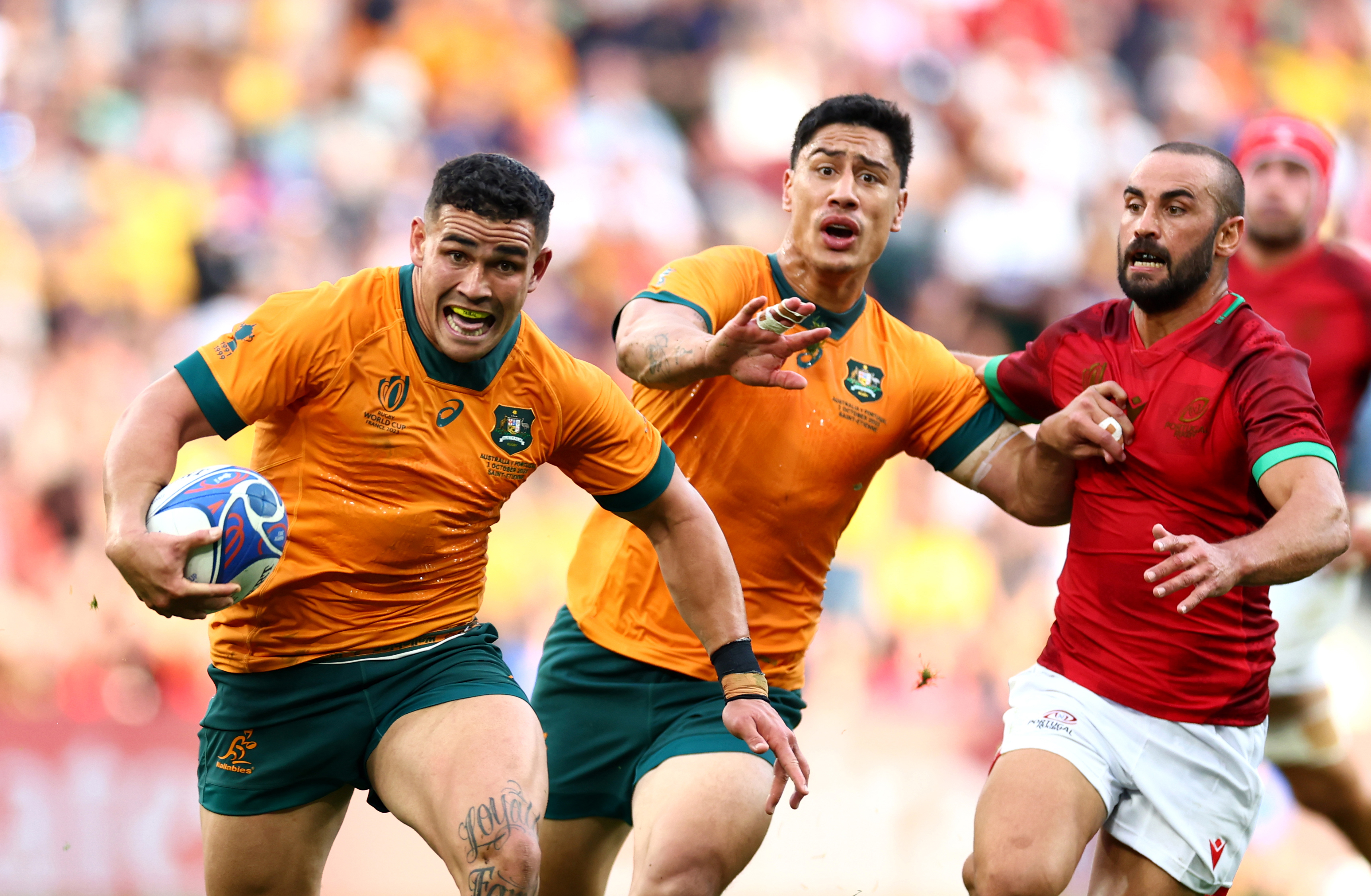 Izaia Perese of Australia breaks with the ball at Stade Geoffroy-Guichard.