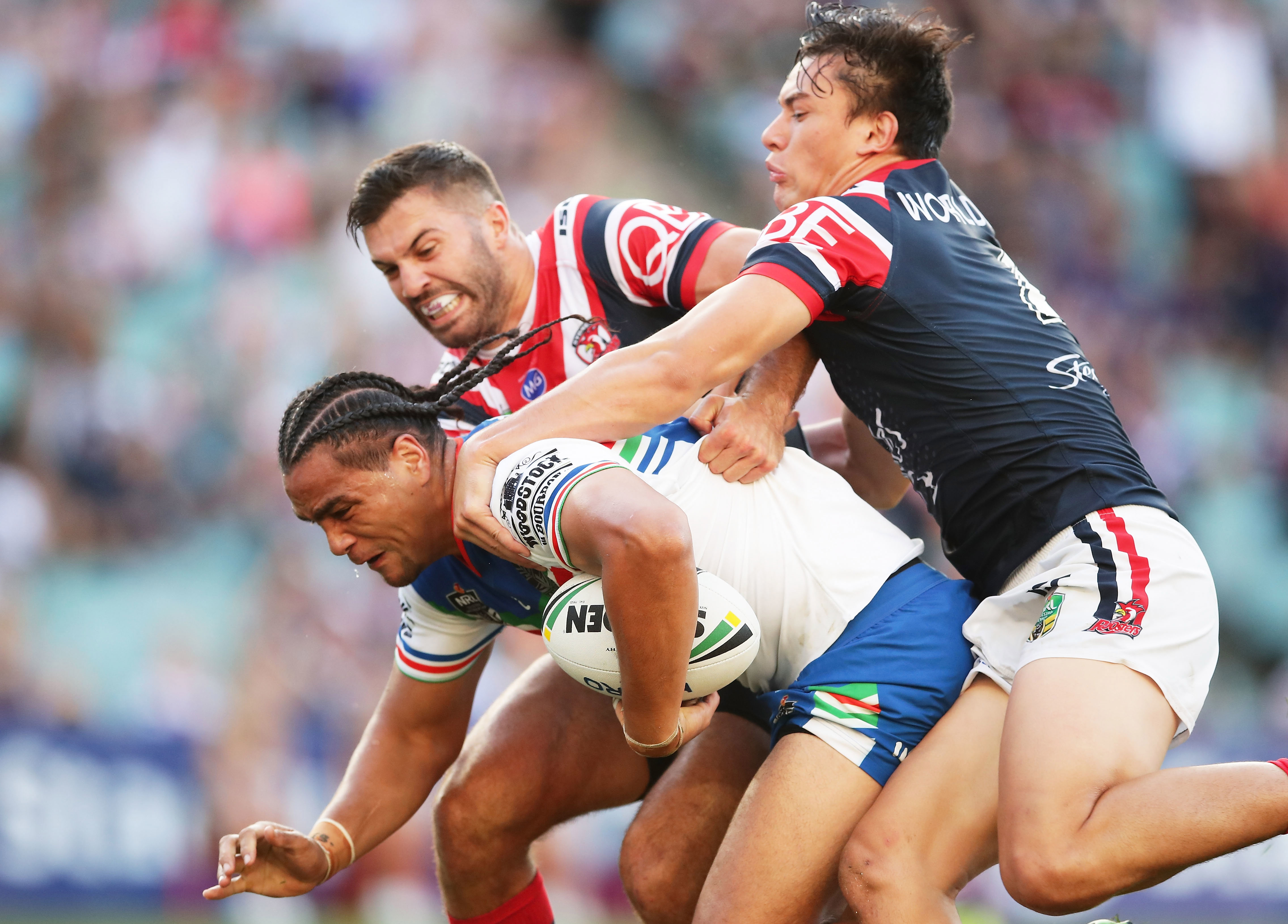 James Tedesco and Joseph Manu make a tackle against the Warriors.