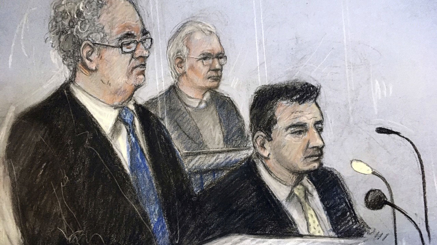 Court artist sketch by Elizabeth Cook of Julian Assange in the dock as his defence team, Edward Fitzgerald QC (left) and Mark Simmons QC, address Belmarsh Magistrates' Court in London for the Wikileaks founder's extradition hearing.