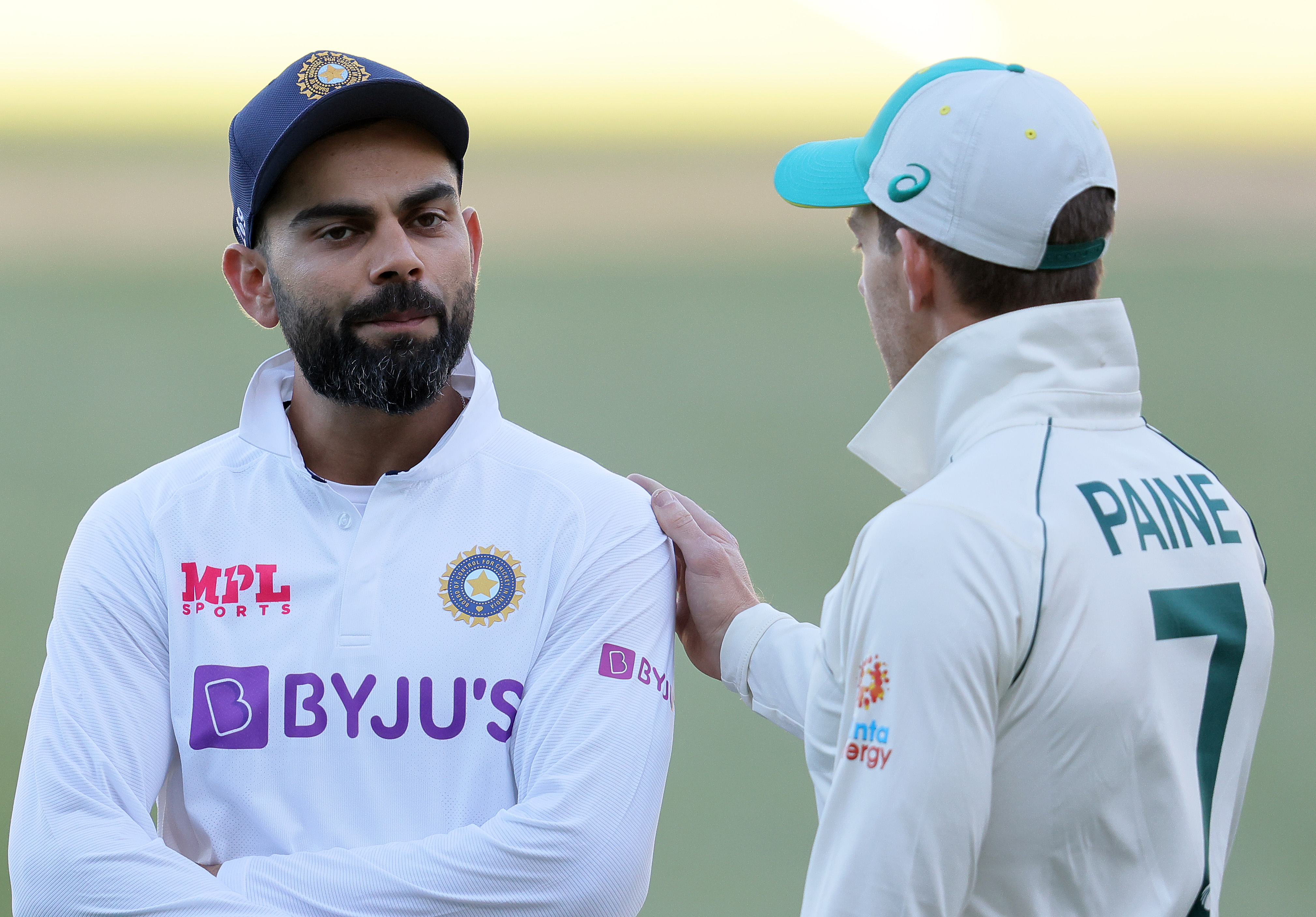 Tim Paine of Australia talks to Virat Kohli of India after play.