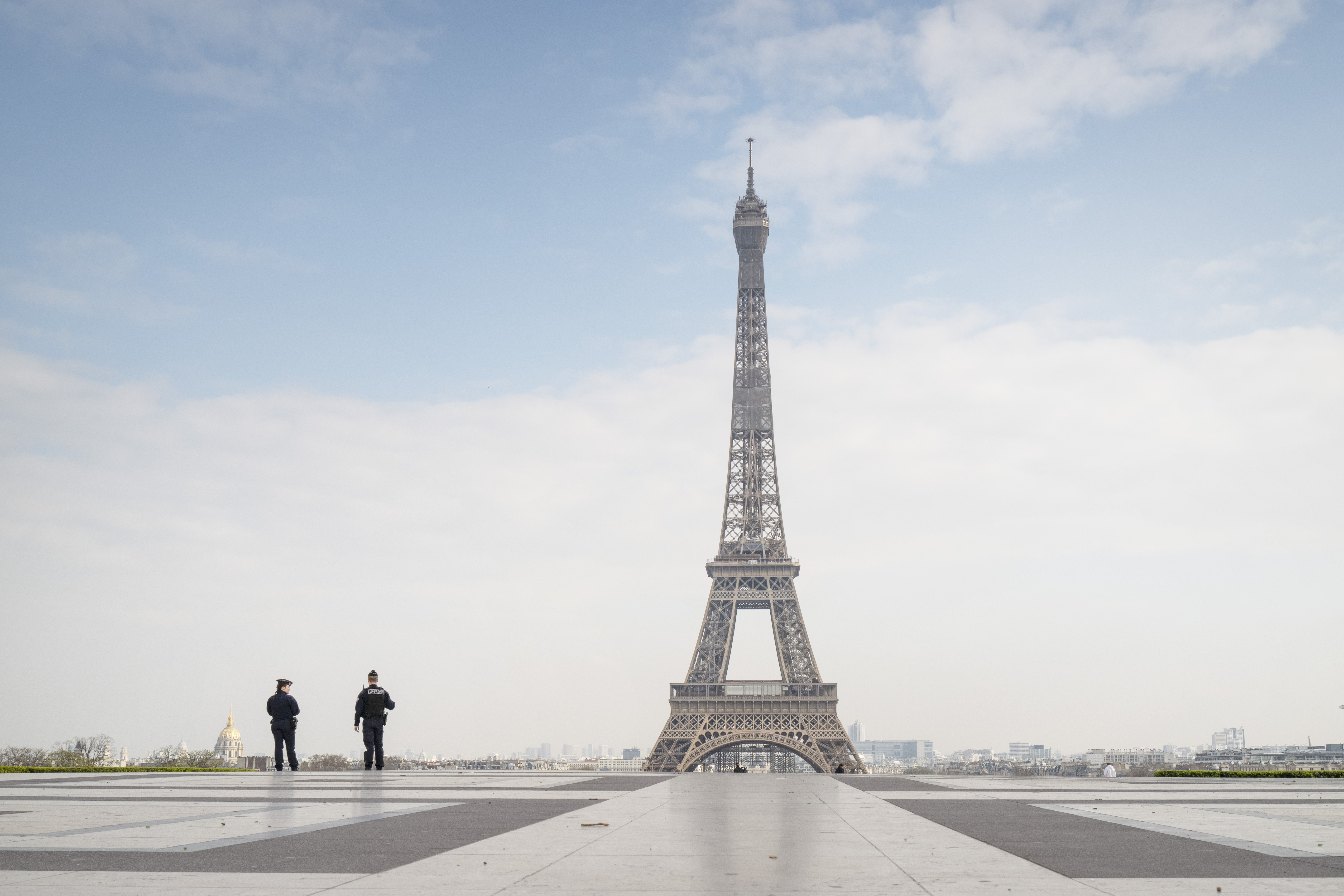 Police patrol an isolated Eiffel Tower