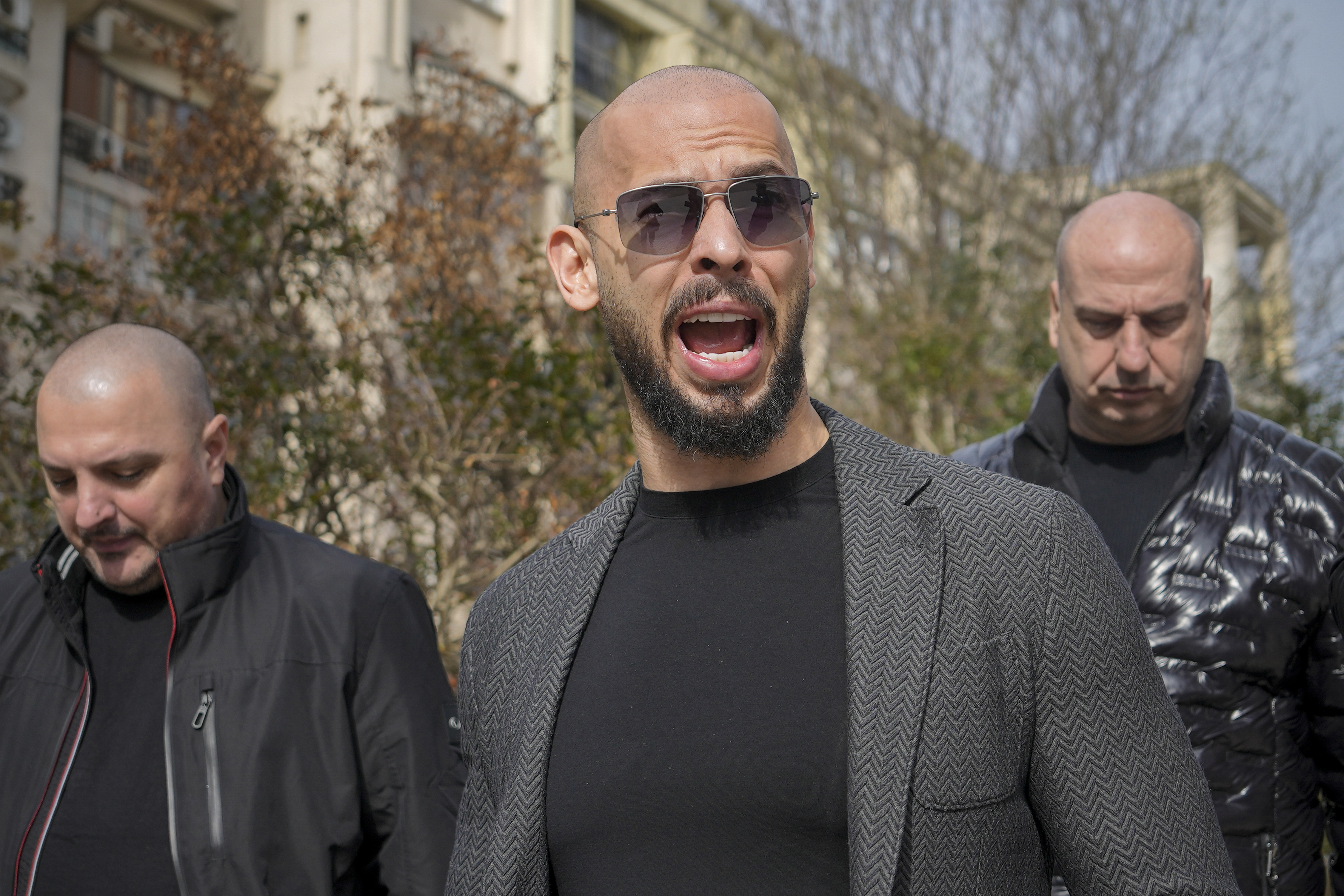 Andrew Tate grimaces as he arrives at the Bucharest Tribunal in Bucharest, Romania, Monday, Feb. 26, 2024. 