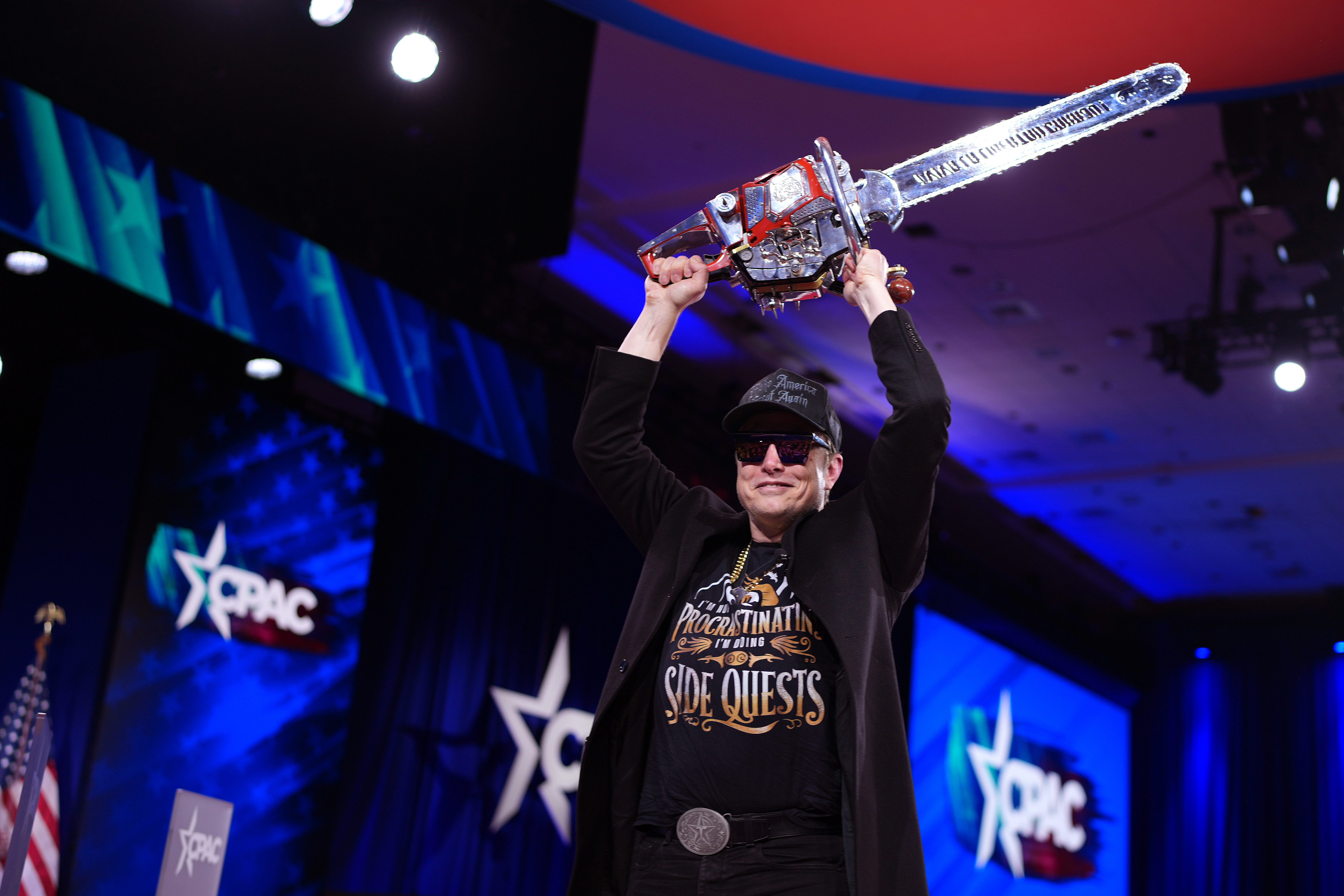 OXON HILL, MARYLAND - FEBRUARY 20: CEO of Tesla and SpaceX Elon Musk leaves the stage holding a chainsaw after speaking at the Conservative Political Action Conference (CPAC) at the Gaylord National Resort Hotel And Convention Center on February 20, 2025 in Oxon Hill, Maryland. The annual four-day gathering brings together conservative U.S. lawmakers, international leaders, media personalities and businessmen to discuss and champion conservative ideas. Argentinian President Javier Milei gifted M