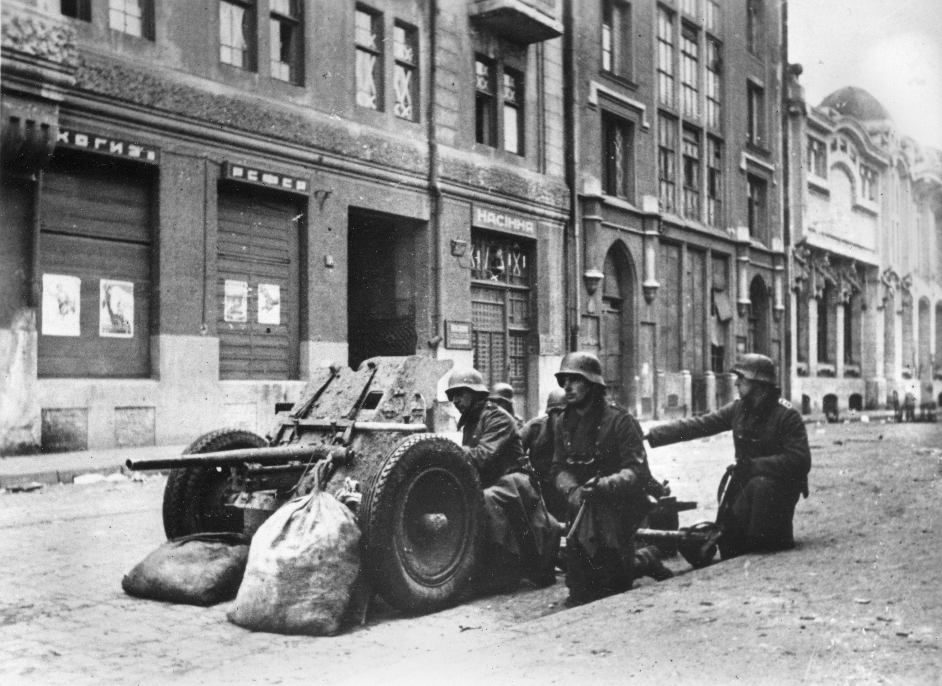 A German anti-tank artillery crew is shown in position in a street of the Russian industrial city Kharkov in the Ukraine during Nazi occupation, Dec. 15, 1941 during World War II. War posters appear on the building at left. (AP Photo)