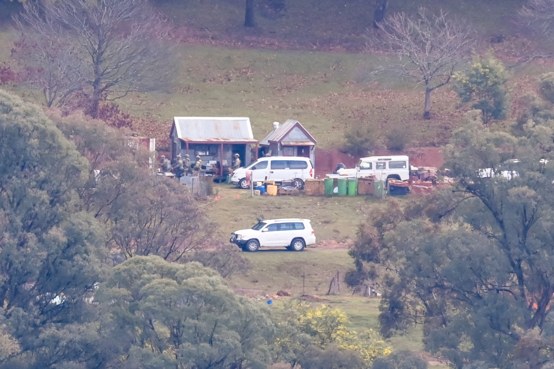 The Age, News, 28/08/2025, photo by Justin McManus. Police search for alleged killer of two Police officers Desmond Freeman. Special Operation Group officers searchiing the property at Porepunkah where Freeman allegedly killed the Police Officers. SOG's searching an outbuilding.