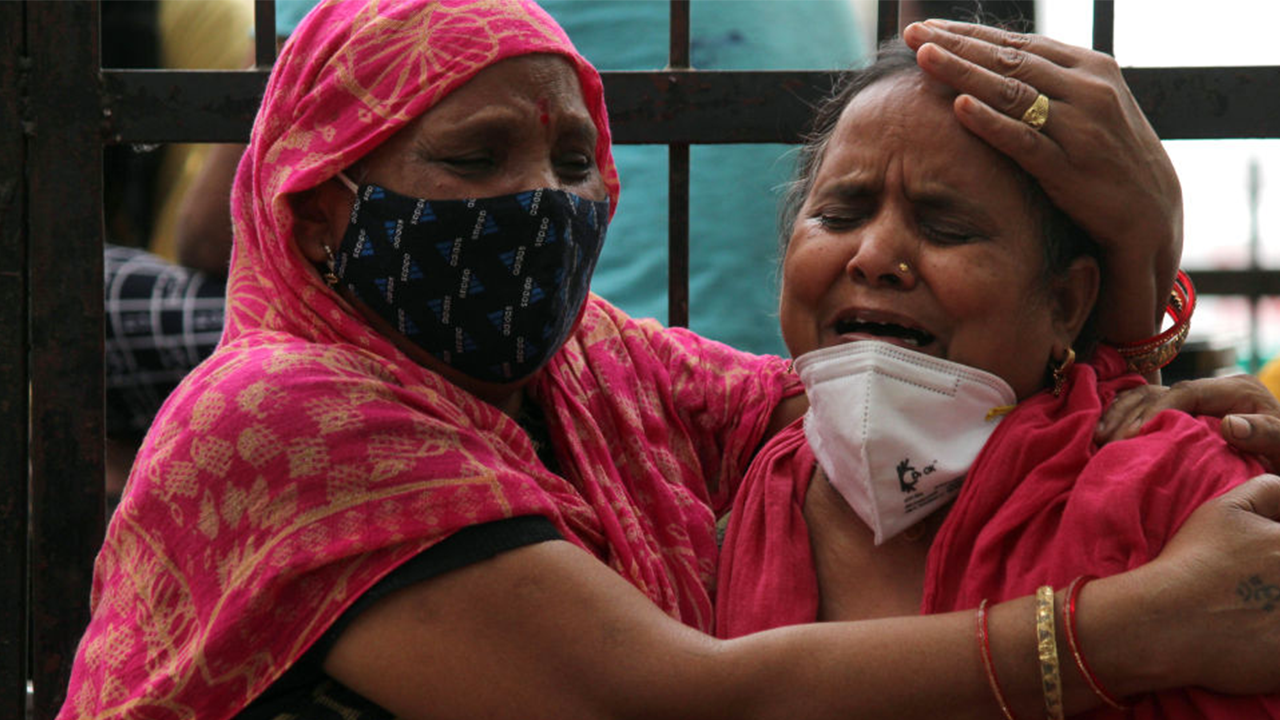 Women mourn the death of a family member, who died due to the coronavirus disease (COVID-19), outside the Lok Nayak Jai Prakash Narayan Hospital (LNJP), one of the largest facilities for coronavirus disease patients, in New Delhi, India on May 4, 2021. (Photo by Mayank Makhija/NurPhoto via Getty Images)