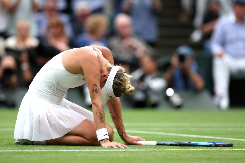 Marketa Vondrousova of Czech Republic falls to the floor as she celebrates.