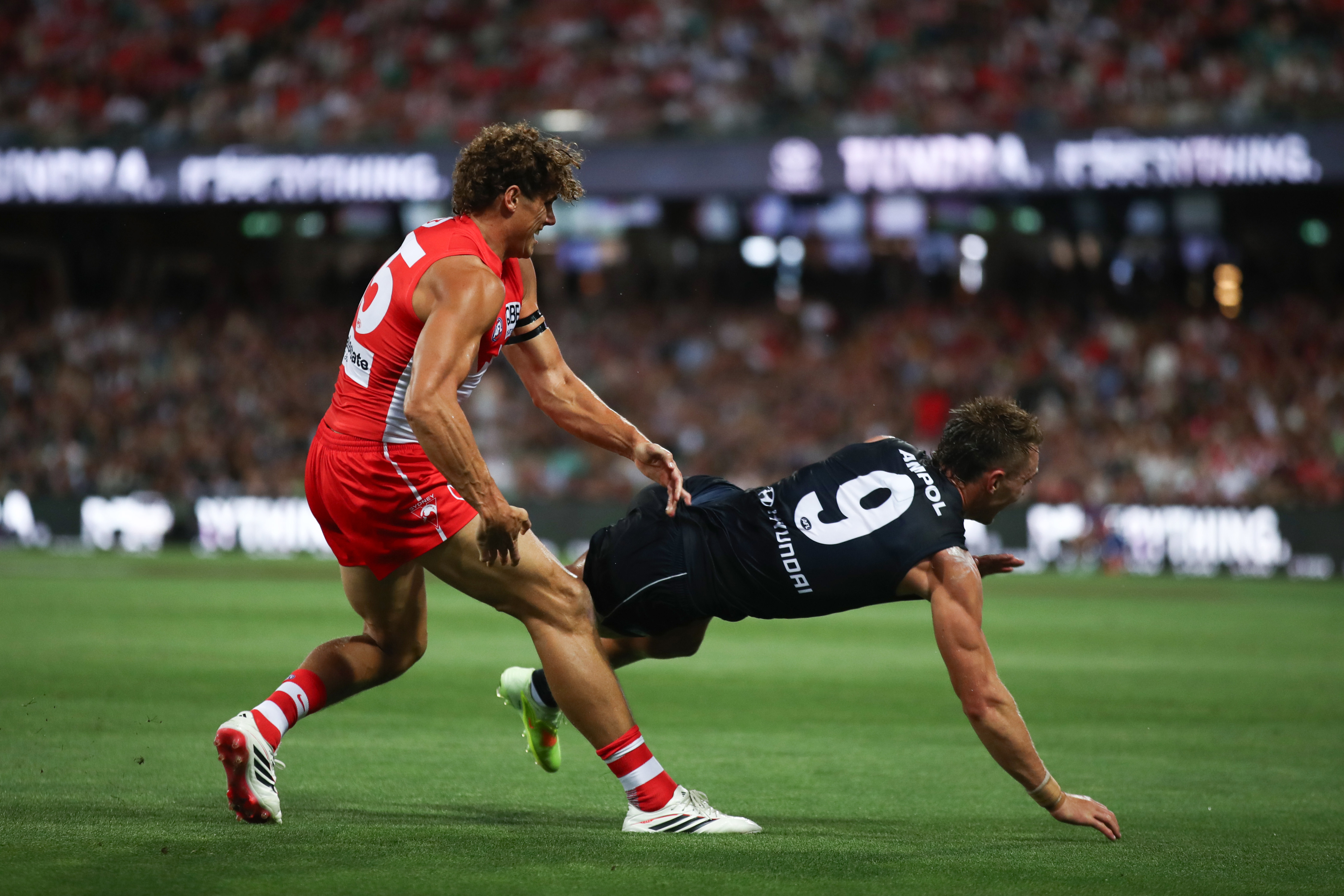Charlie Curnow of the Swans clashes with Patrick Cripps of the Blues.