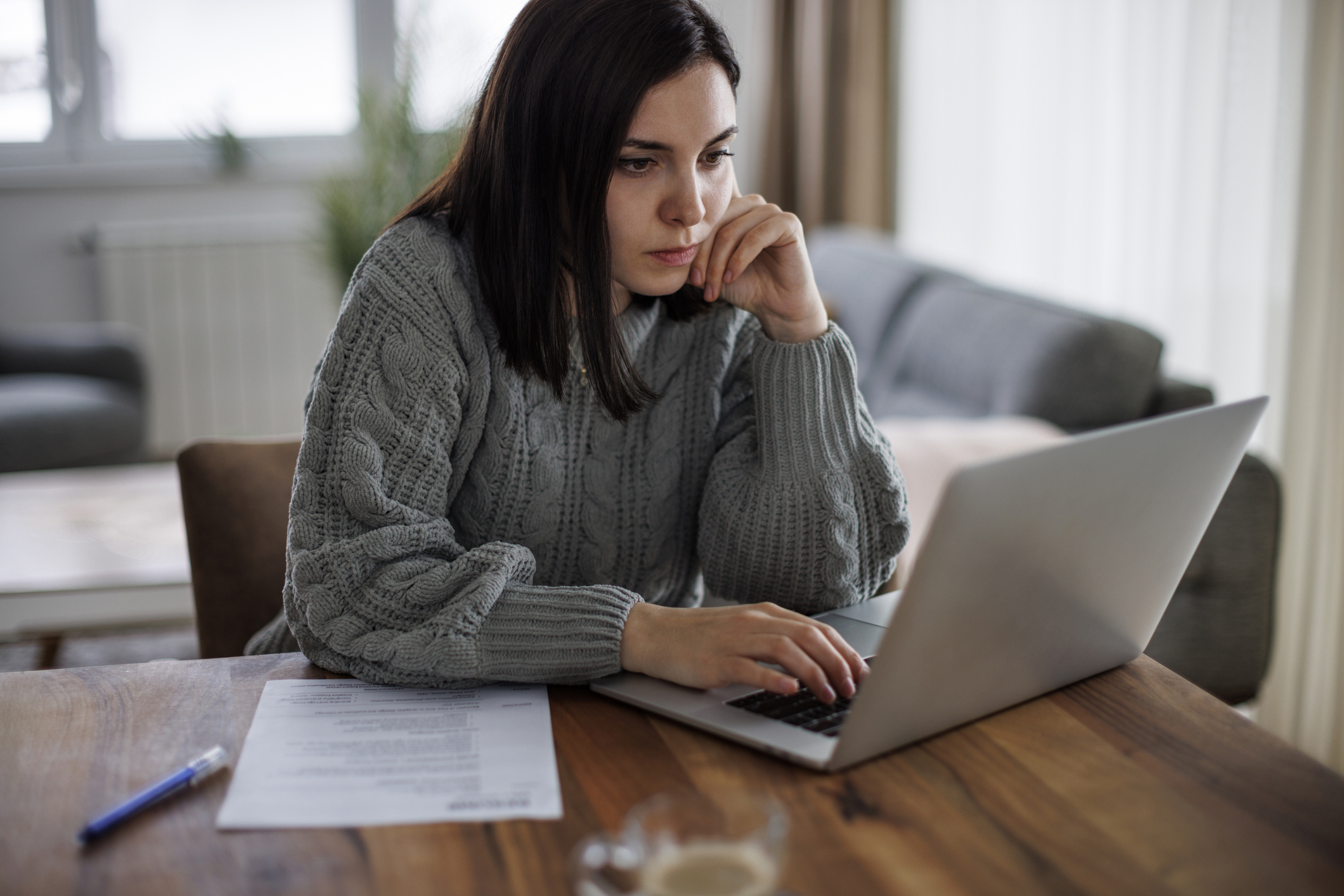 Determined woman reviewing job opportunities online