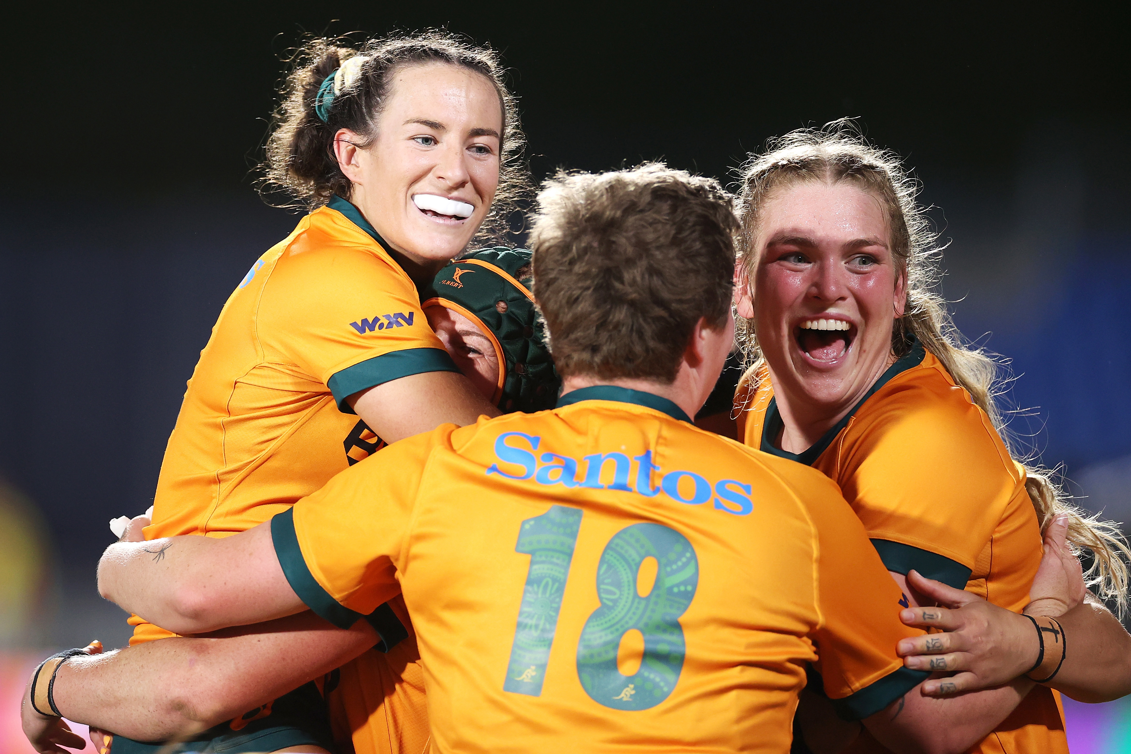 Maya Stewart, Emily Chancellor, Bridie O'Gorman and Kaitlan Leaney celebrate victory during the WXV1 match between Australia and Wales.