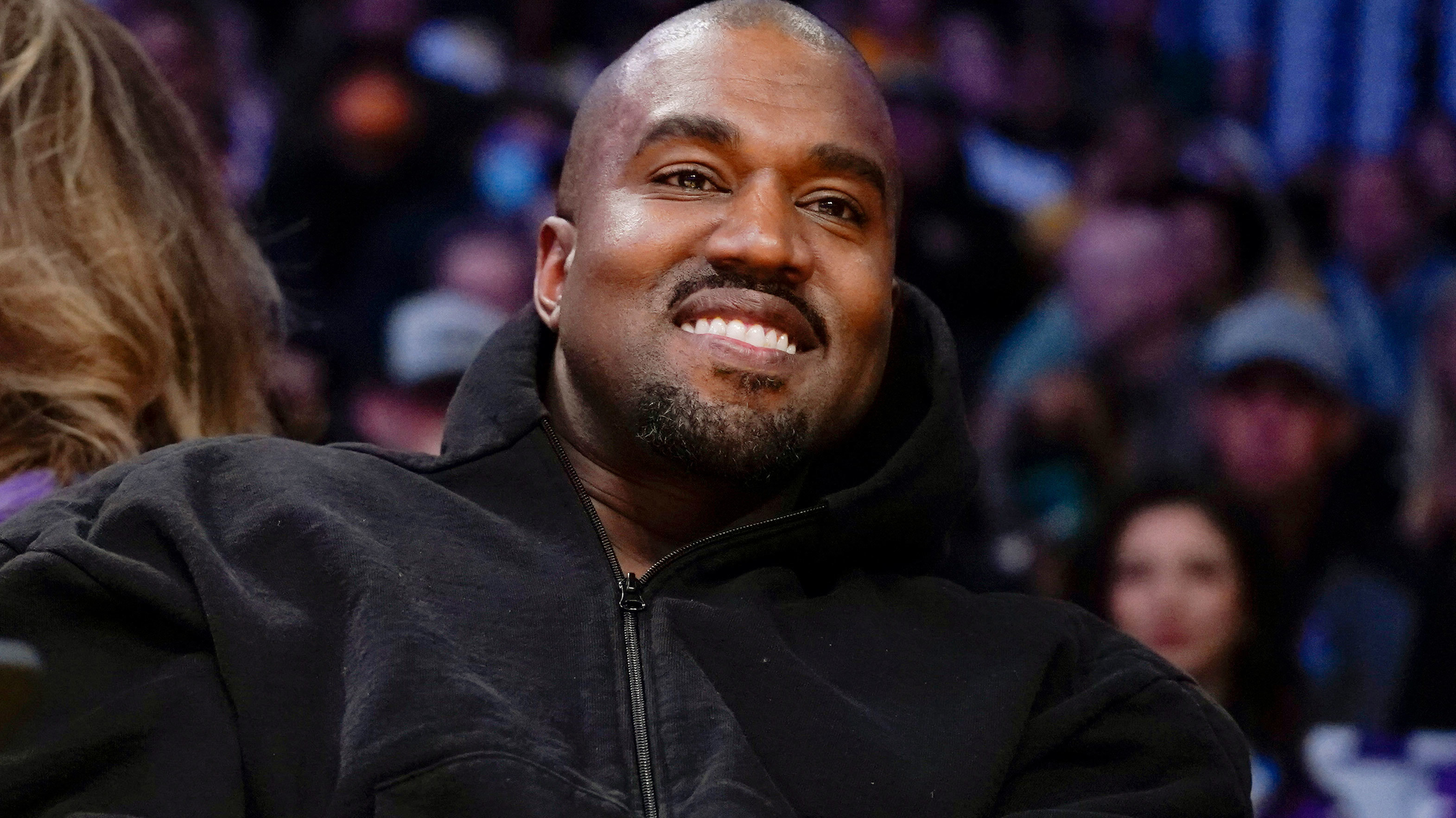 Kanye West, known as Ye, watches the first half of an NBA basketball game between the Washington Wizards and the Los Angeles Lakers in Los Angeles, on March 11, 2022. 