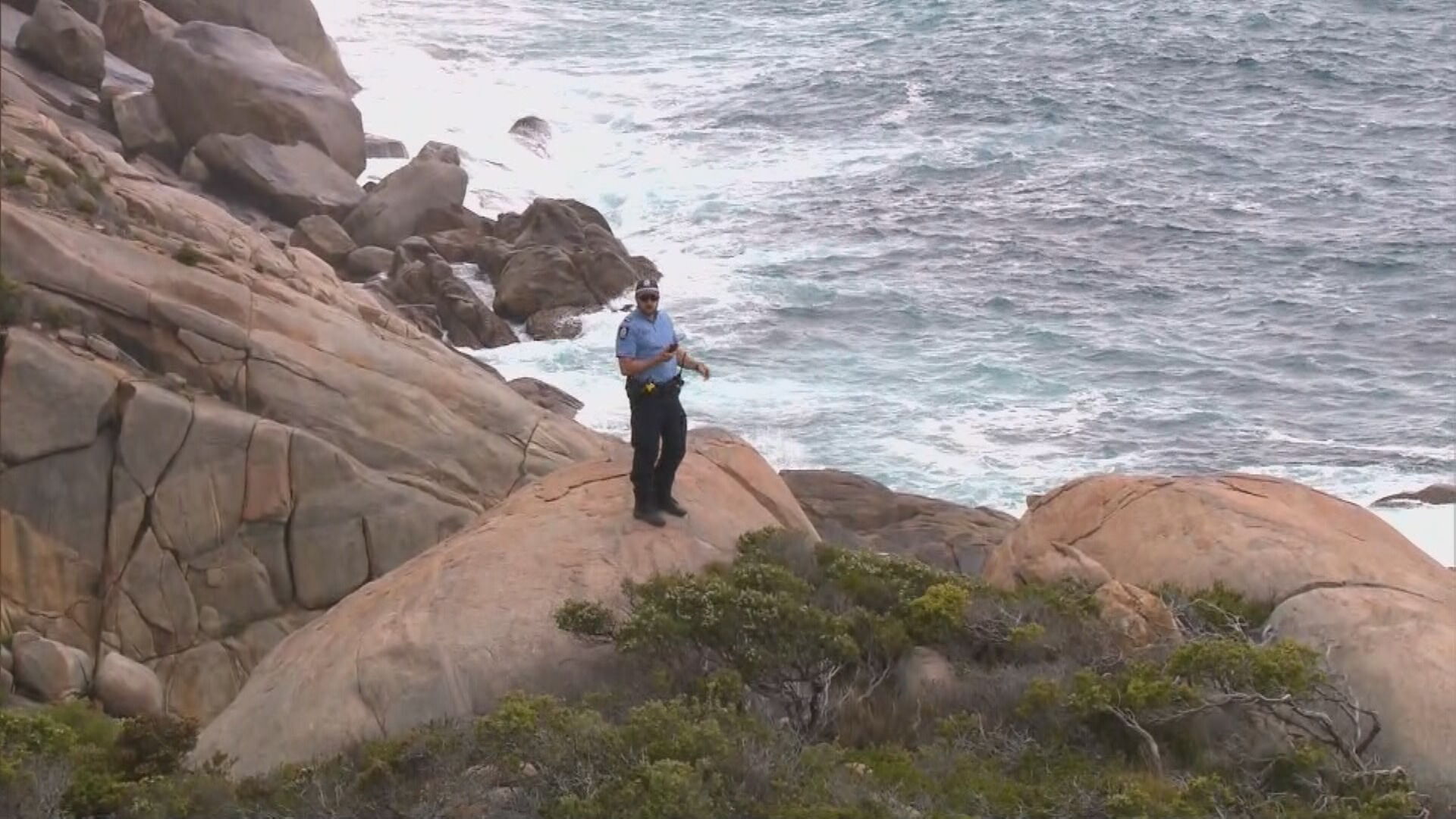 An officer scours the waters off Mermaid Beach in search for the missing fisherman.