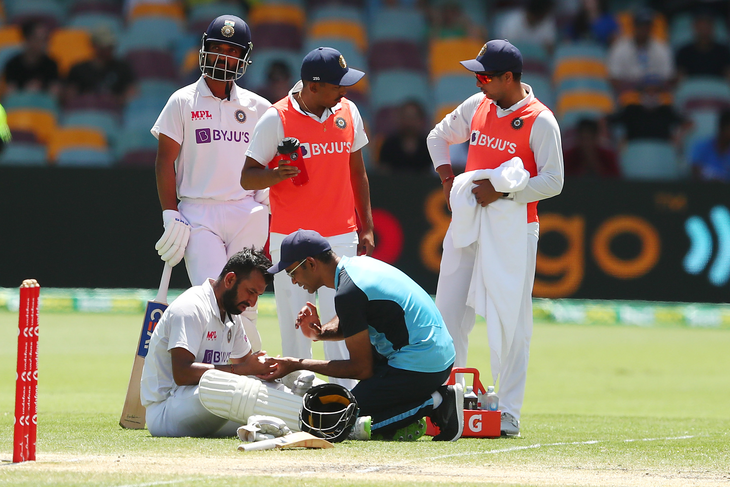 Cheteshwar Pujara of India gets treatment during day five.