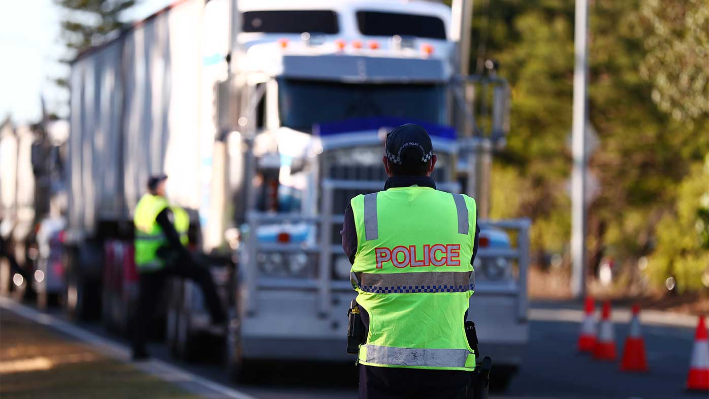 Queensland Police stop trucks at the Queensland border with NSW.