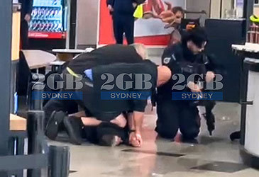 Still from supplied footage of AFP airport arrest (2GB/Nine)