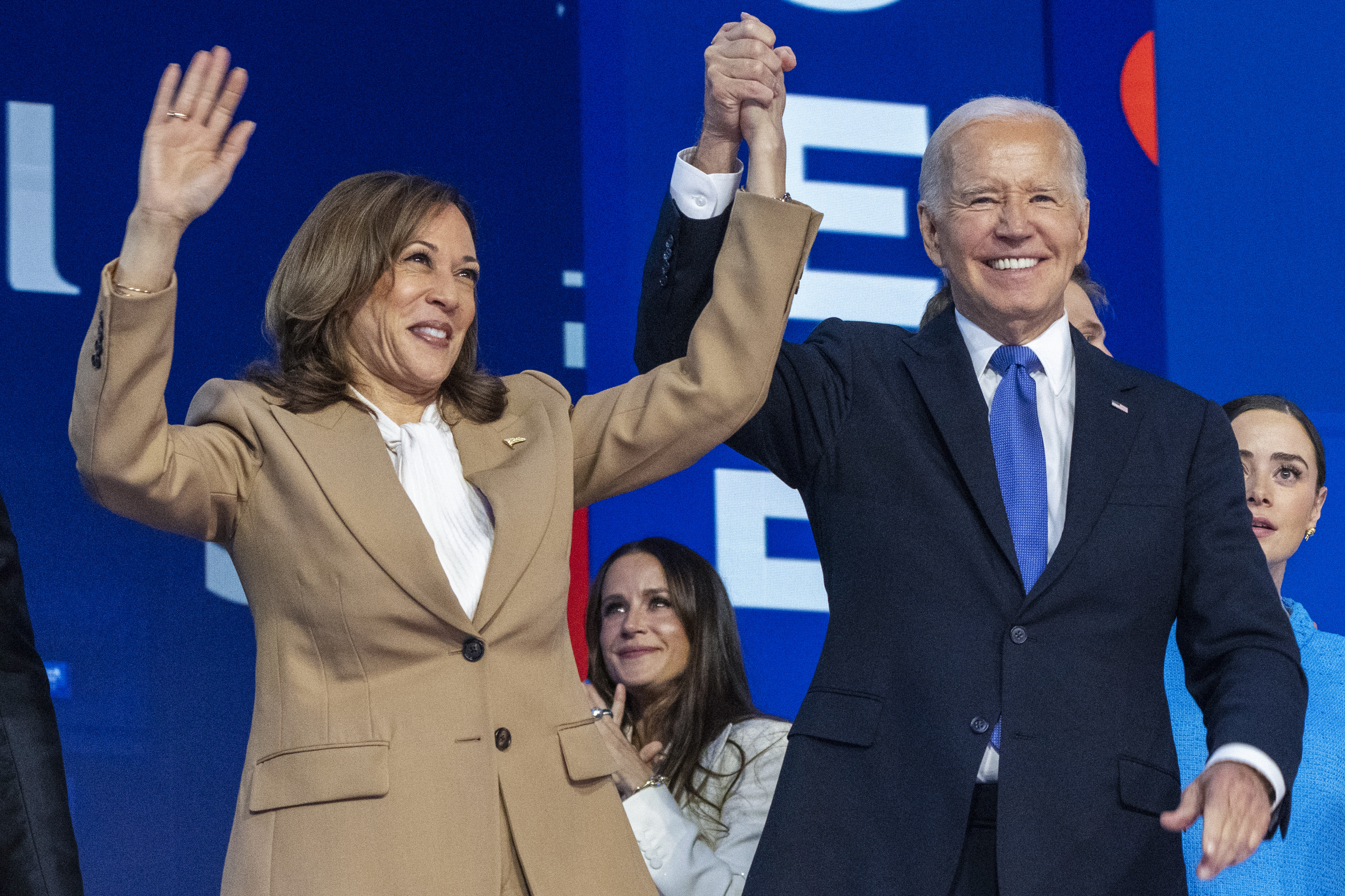 La candidata presidencial demócrata, la vicepresidenta Kamala Harris (izquierda), se toma de la mano con el presidente Joe Biden en la Convención Nacional Demócrata, el lunes 19 de agosto de 2024, en Chicago. (Foto AP/Jacquelyn Martin)