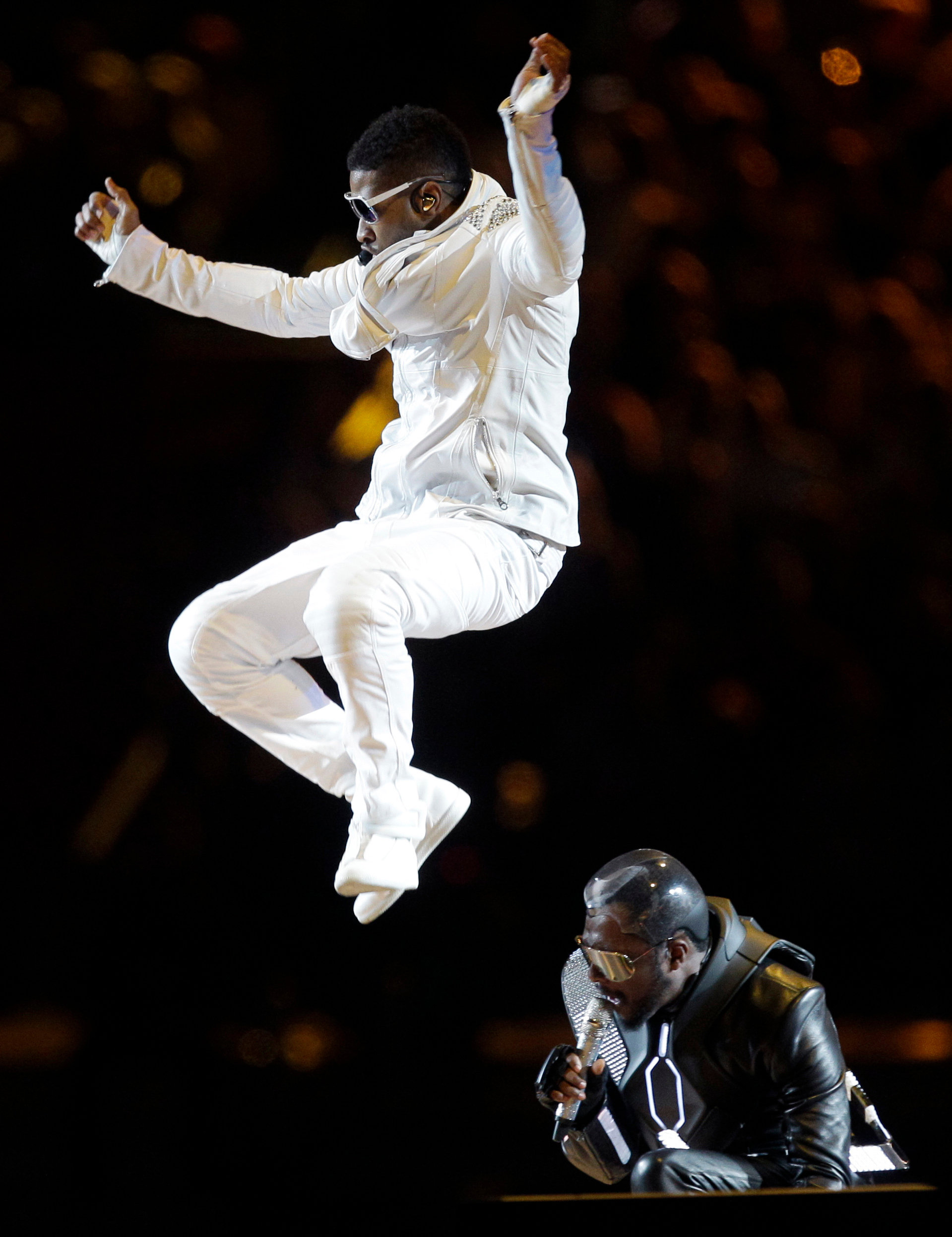 Usher, top, performs with the Black Eyed Peas' will.i.am during halftime of the NFL football Super Bowl XLV game between the Green Bay Packers and the Pittsburgh Steelers on Sunday, Feb. 6, 2011, in Arlington, Texas. 