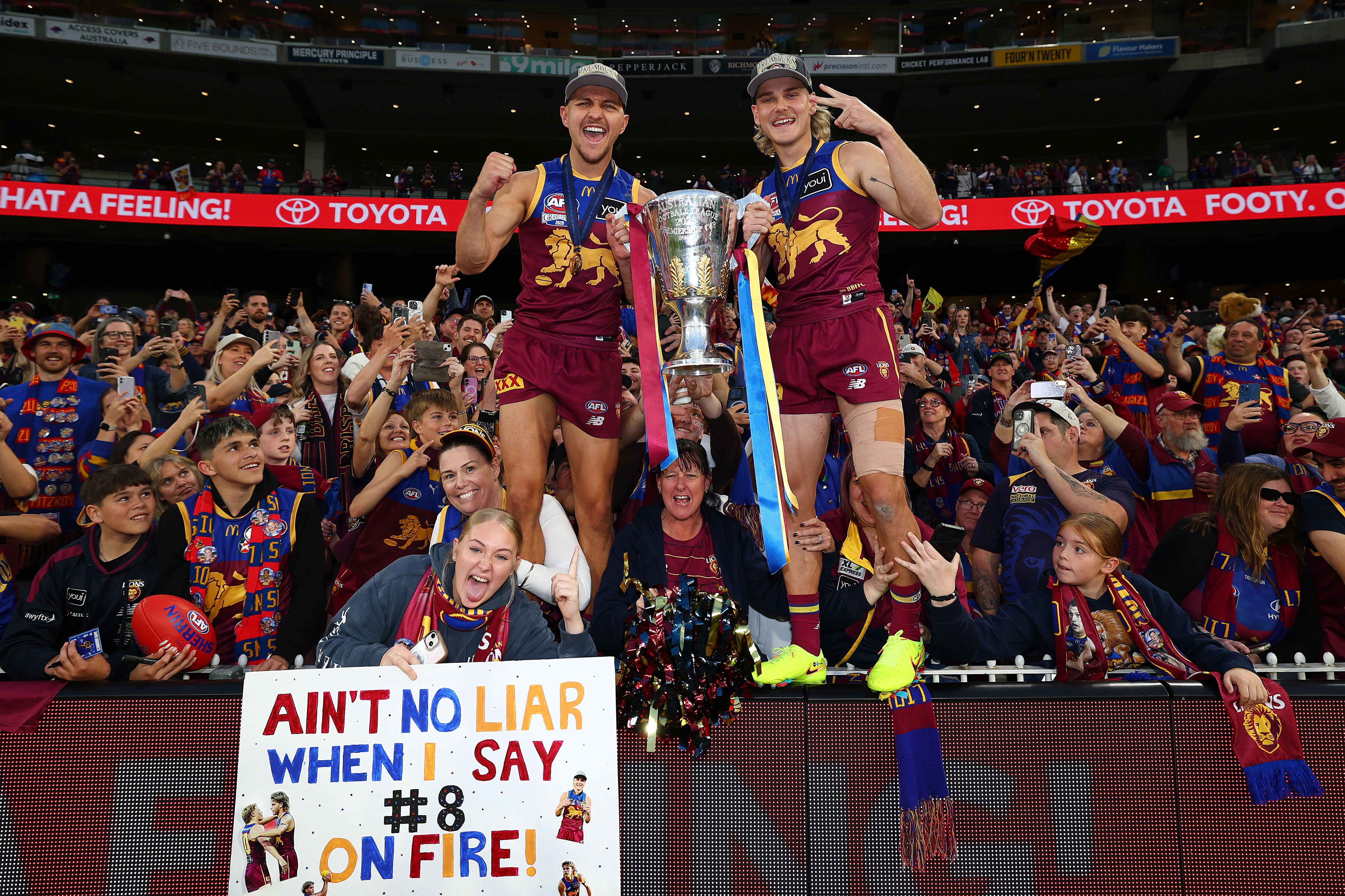 MELBOURNE, AUSTRALIA - SEPTEMBER 27: Kai Lohmann and Will Ashcroft of the Lions celebrates with the trophy after winning the AFL Grand Final match between Geelong Cats and Brisbane Lions at Melbourne Cricket Ground on September 27, 2025 in Melbourne, Australia. (Photo by Daniel Pockett/AFL Photos/via Getty Images)