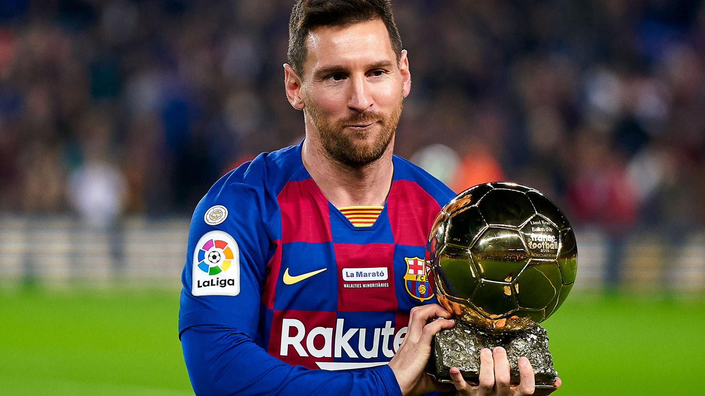  Lionel Messi of FC Barcelona holds up his sixth Ballon d'Or