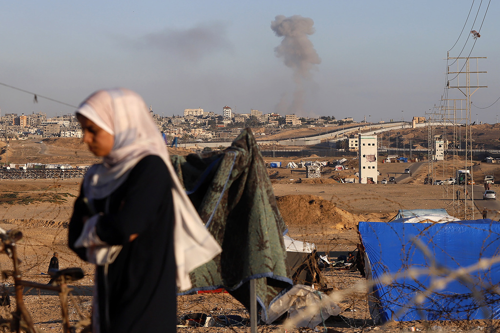 Smoke rises following an Israeli airstrike on buildings near the separating wall between Egypt and Rafah, southern Gaza Strip, Monday, May 6, 2024. (AP Photo/Ramez Habboub)