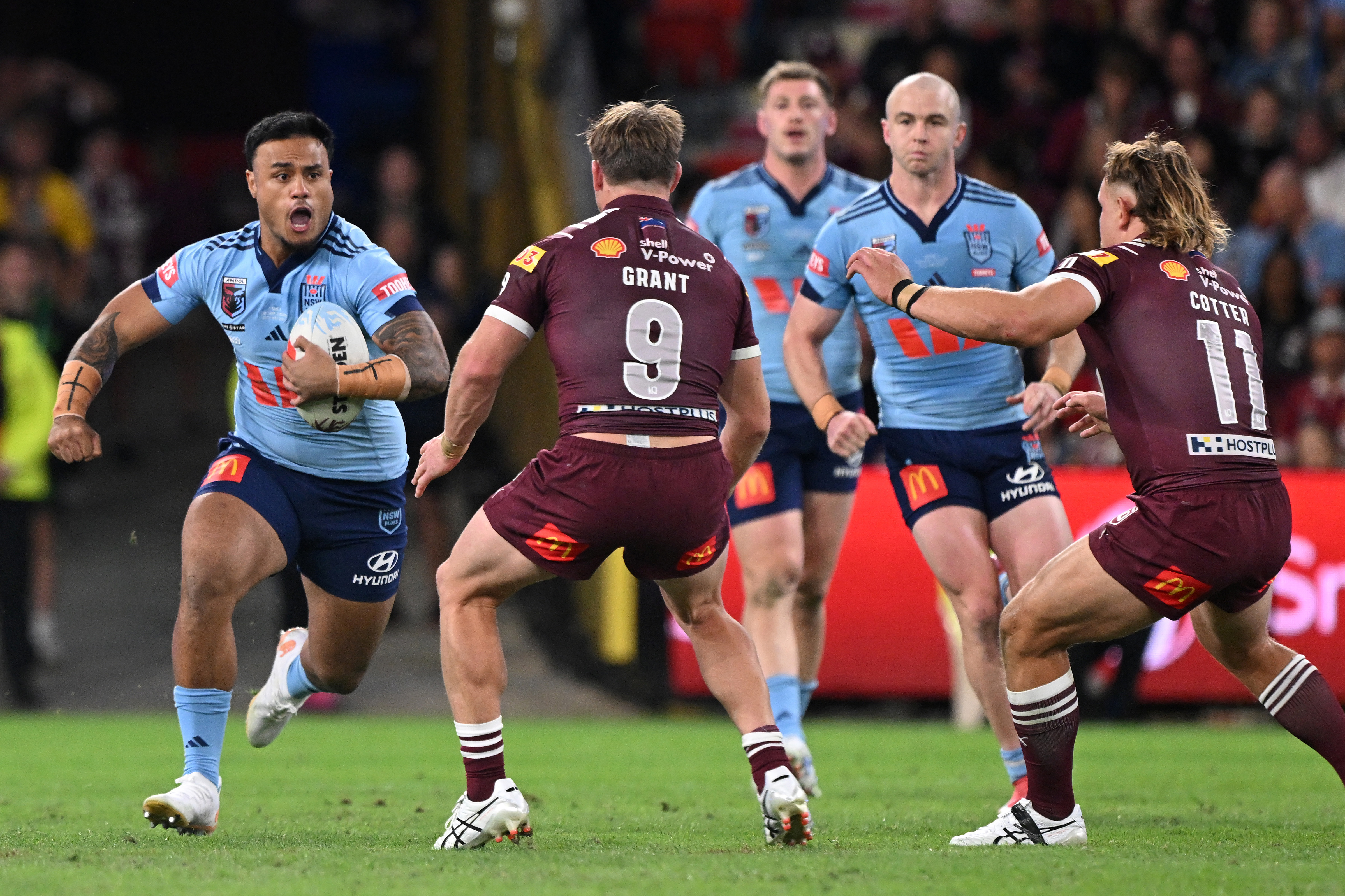 Spencer Leniu charges into the Queensland defence.