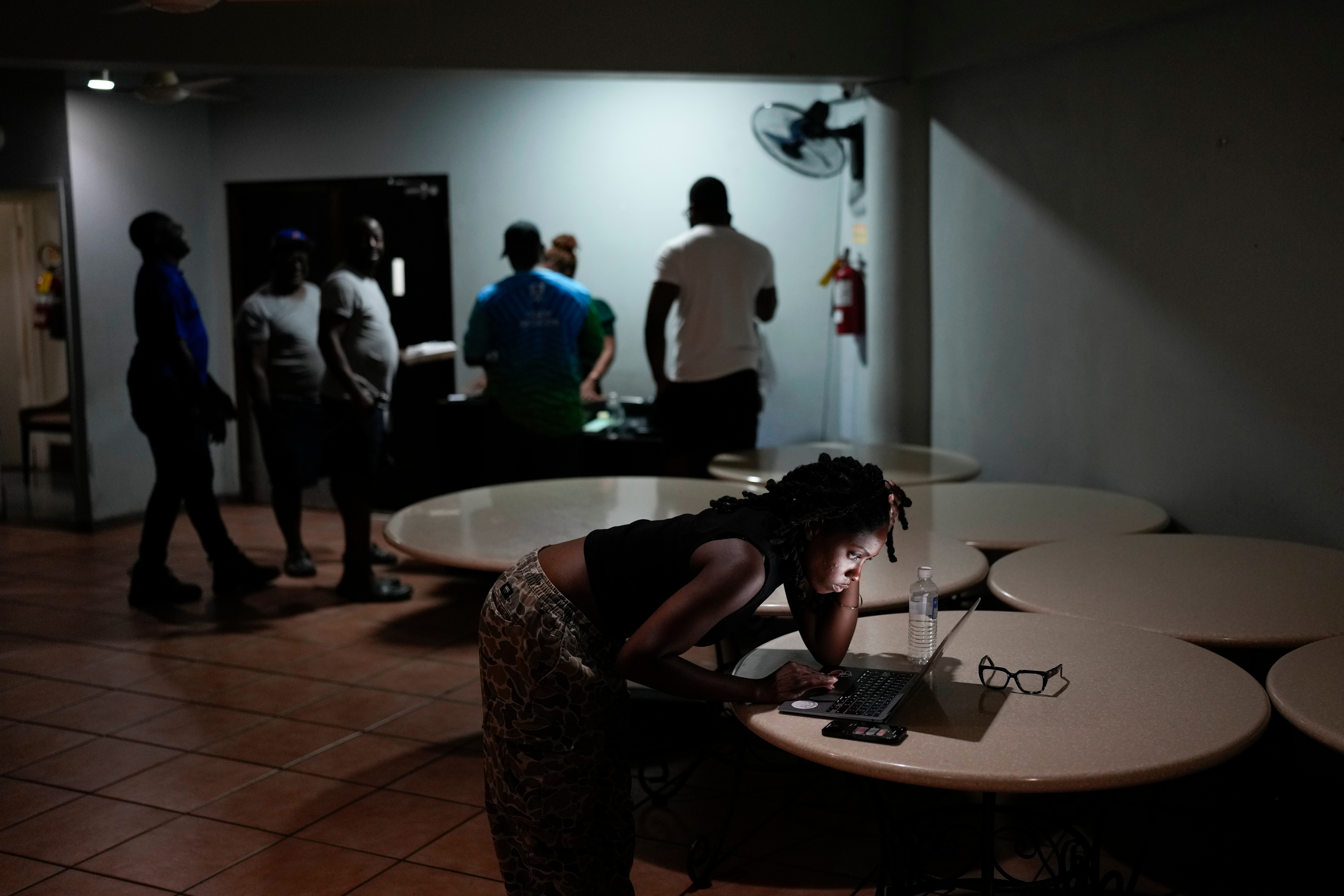 A woman video chats with a friend ahead of Hurricane Melissa's forecast arrival in Kingston, Jamaica, Monday, Oct. 27, 2025. (AP Photo/Matias Delacroix)