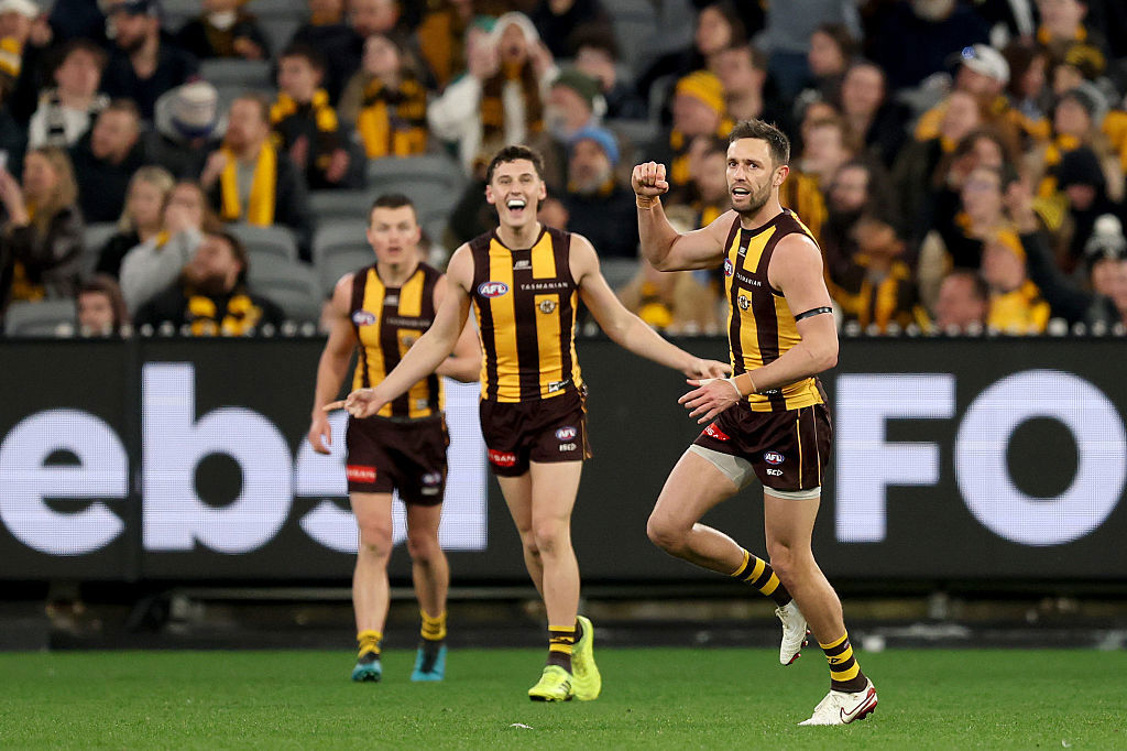 Jack Gunston of the Hawks celebrates kicking a goal.
