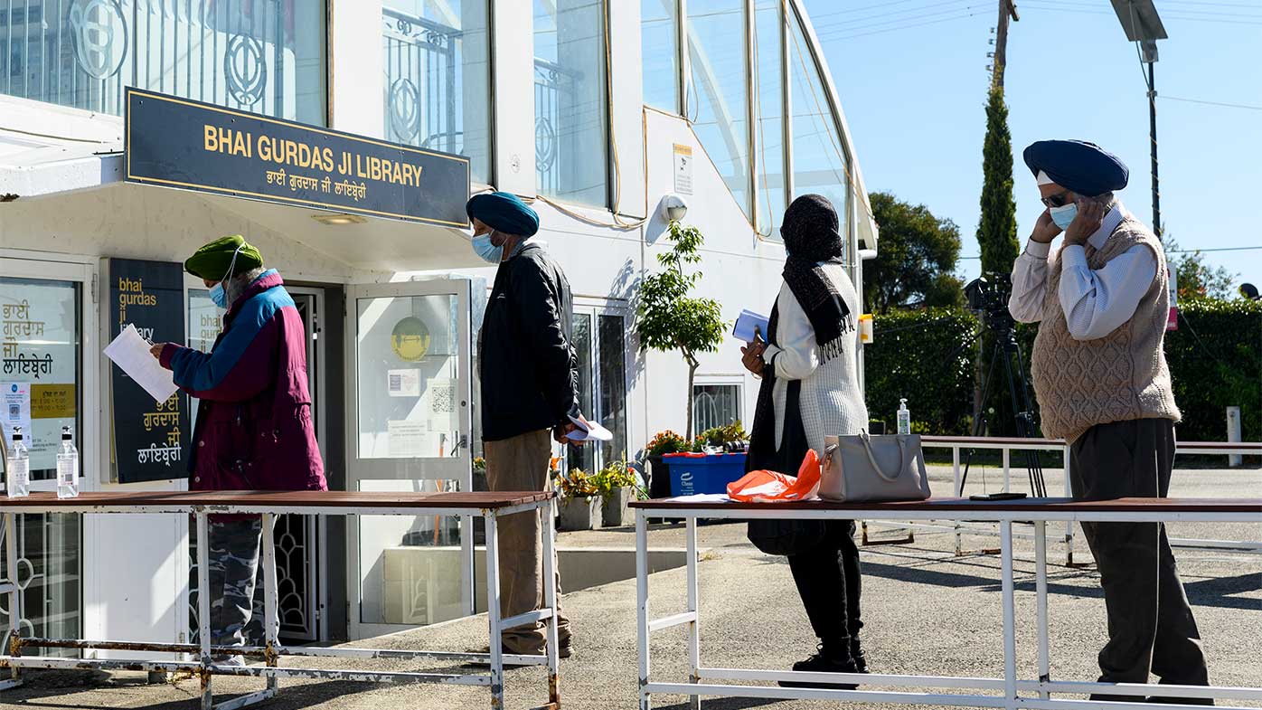 People wait for their COVID-19 vaccination at a pop-up clinic at Gurdwara Sahib Temple in Glenwood.