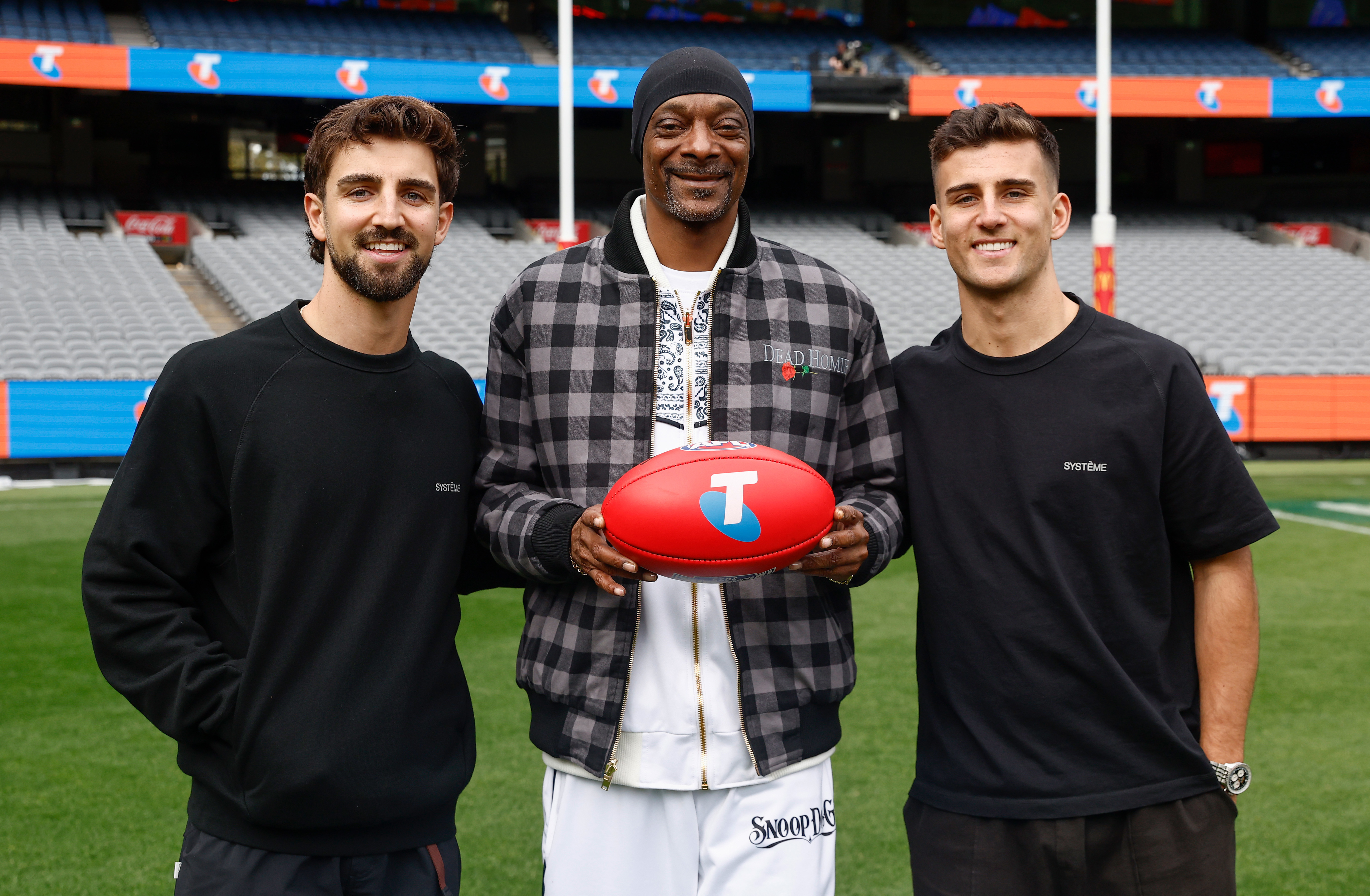 Snoop Dogg poses with Josh Daicos (left) and Nick Daicos of the Magpies during an AFL Telstra Grand Final Entertainment Media Opportunity at the MCG.