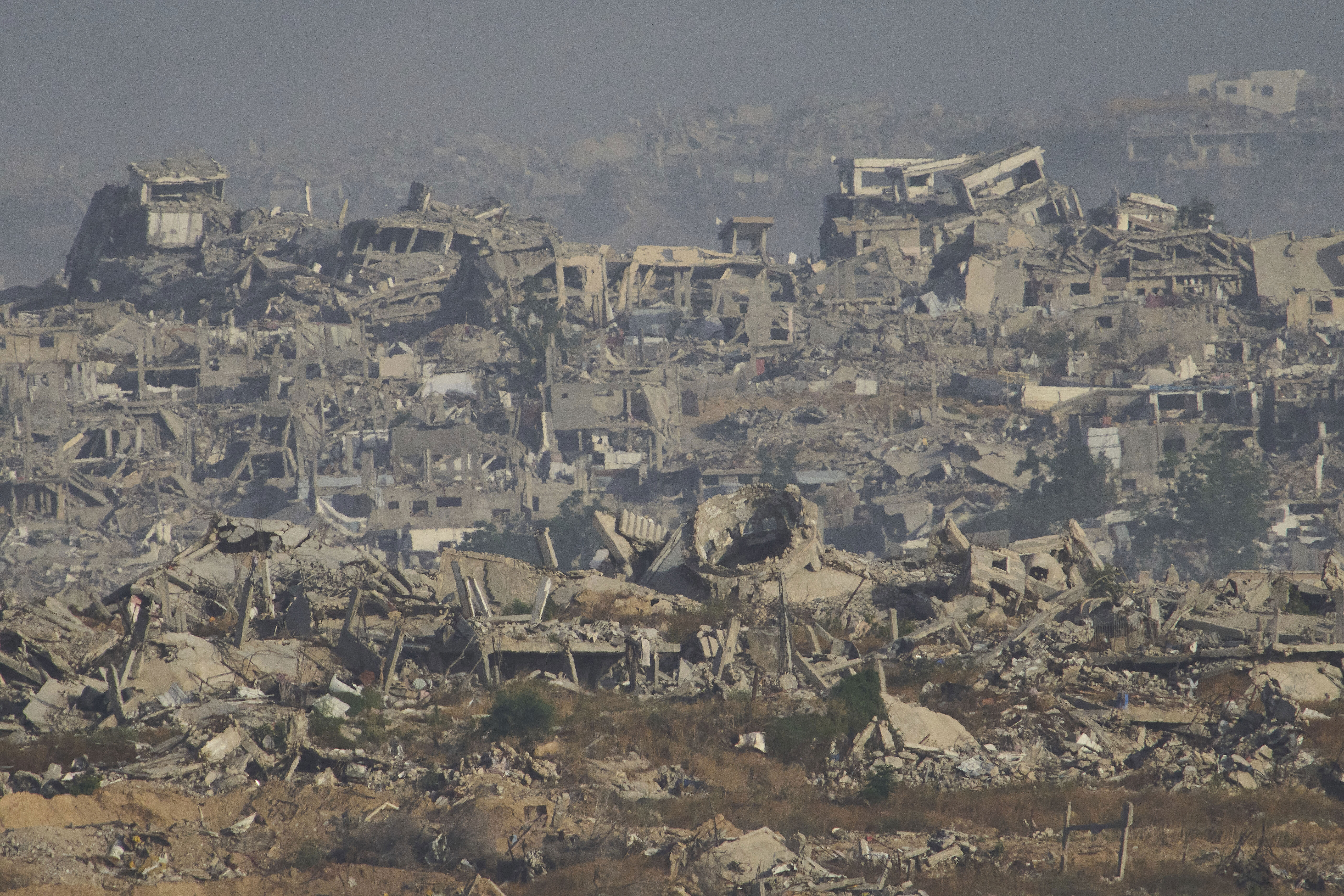 Destroyed buildings in Gaza Strip are seen from southern Israel, Monday, May 26, 2025. (AP Photo/Ariel Schalit)