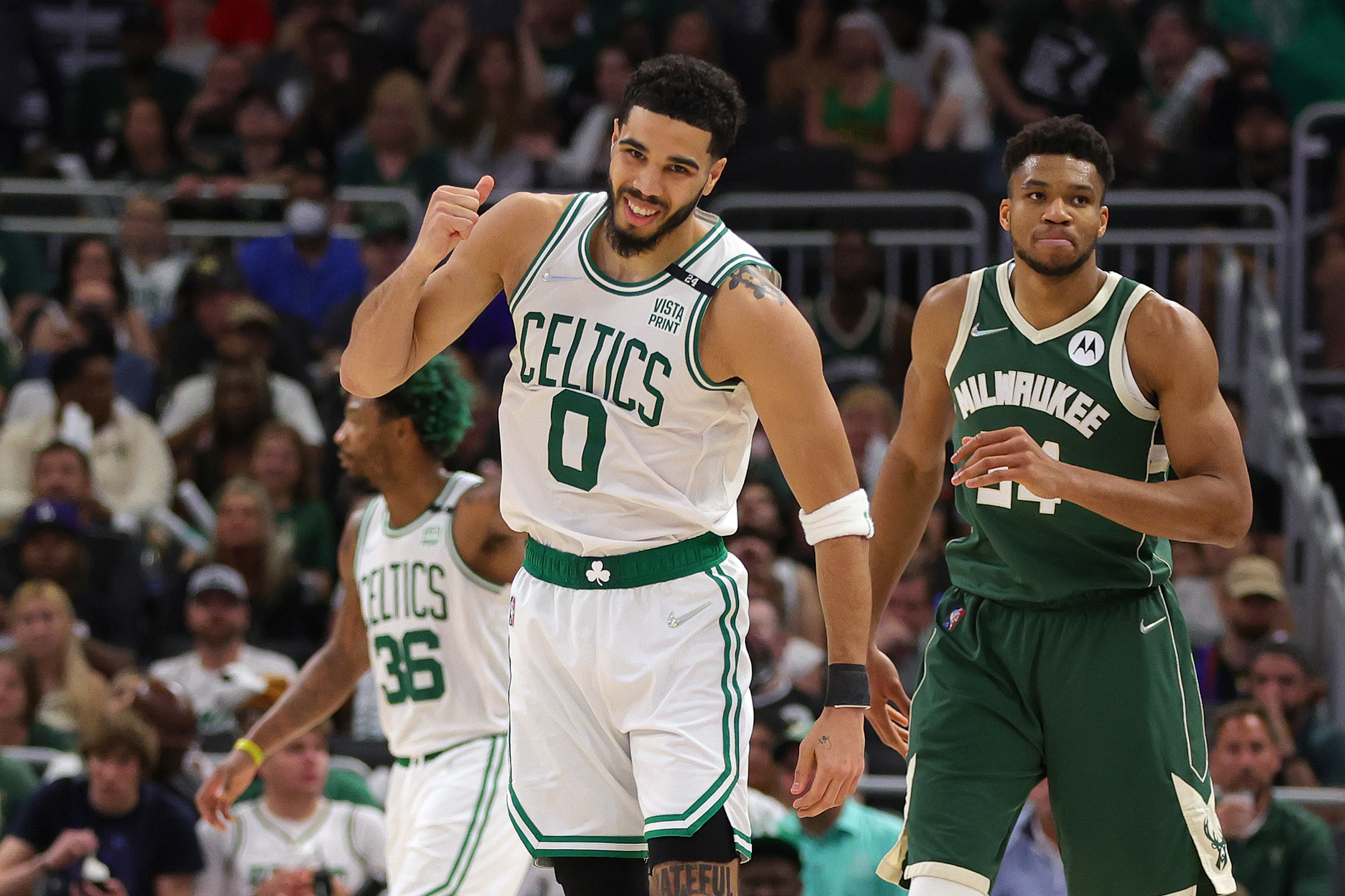 Jayson Tatum celebrates a basket against Giannis Antetokounmpo during game six of the 2022 NBA playoffs Eastern Conference semifinals.