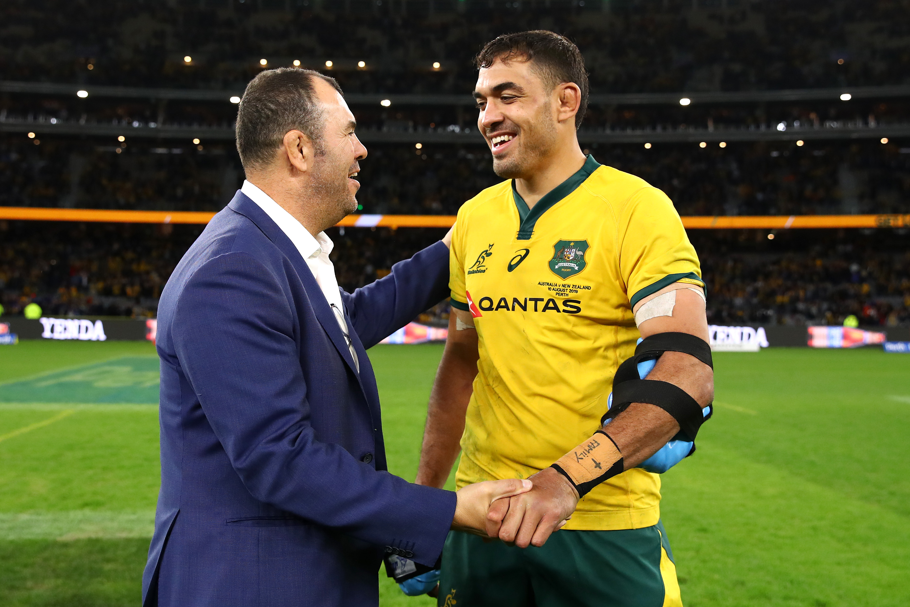 Rory Arnold and Michael Cheika embrace after beating the All Blacks at Optus Stadium.