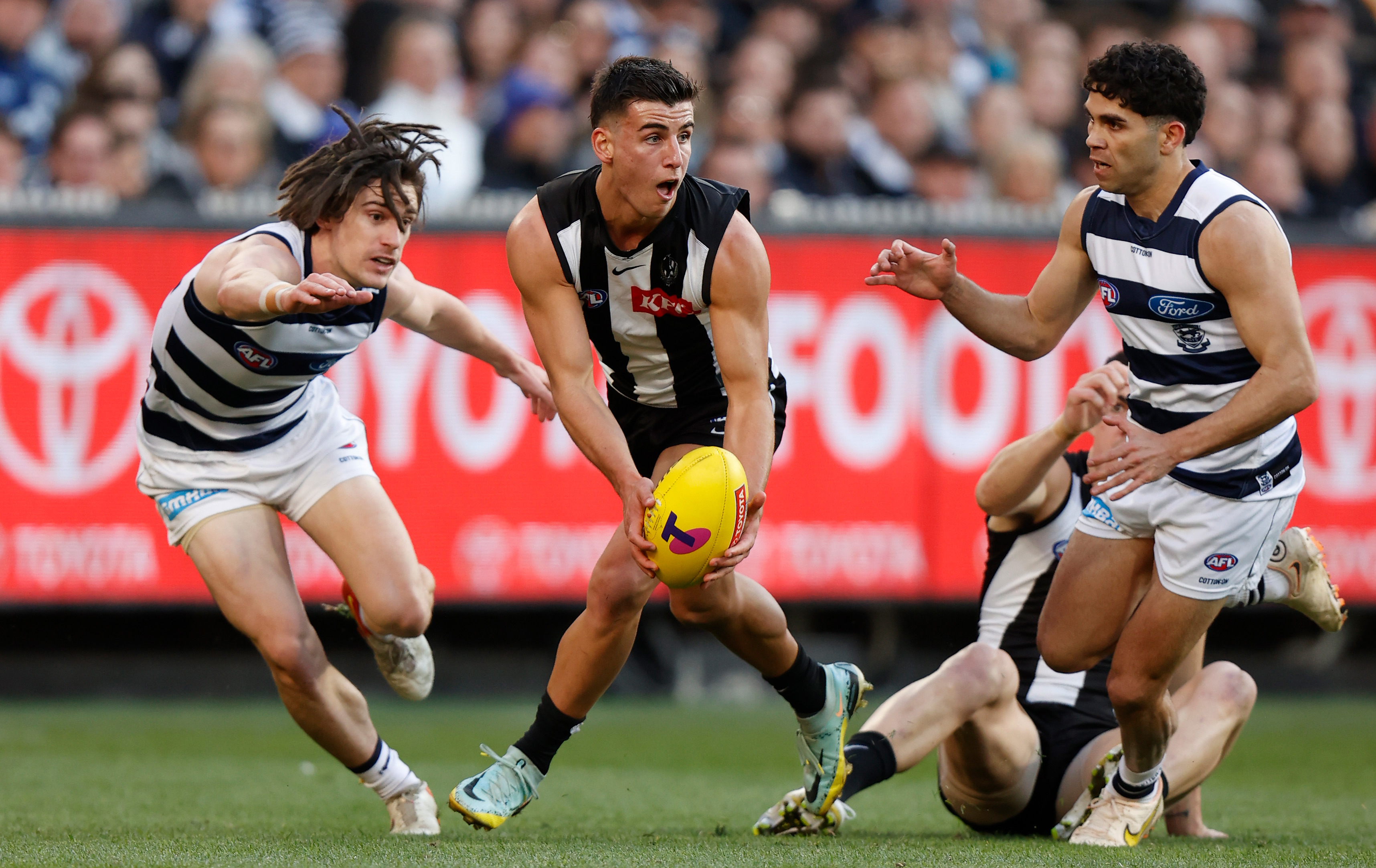 Nick Daicos of the Magpies is chased by Gryan Miers of the Cats during the 2022 AFL First Qualifying Final.