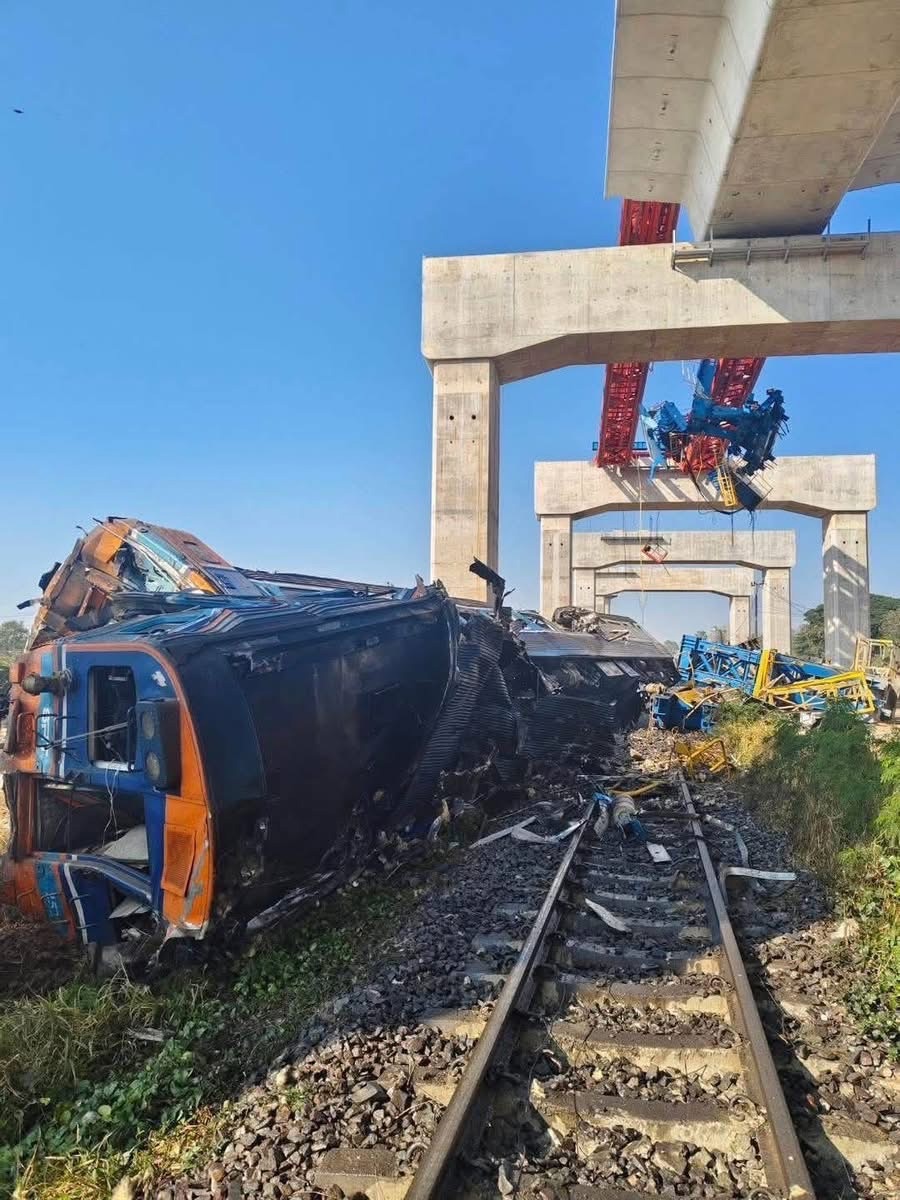 Rescue workers stood on top of overturned railways carriages, some of them with gaping holes torn on their sides,
