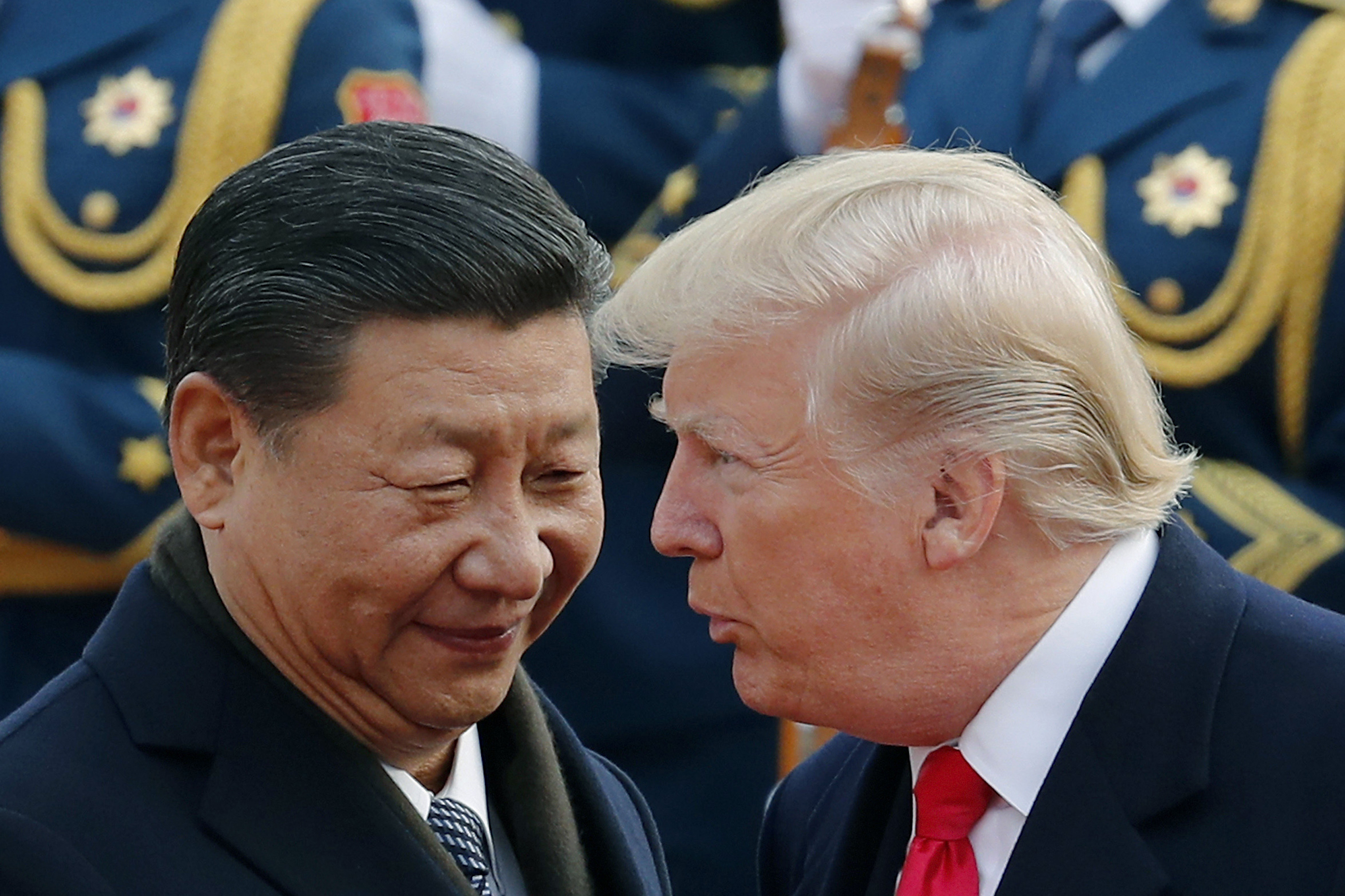 US President Donald Trump chats with Chinese President Xi Jinping during a welcome ceremony at the Great Hall of the People in Beijing, in 2017.