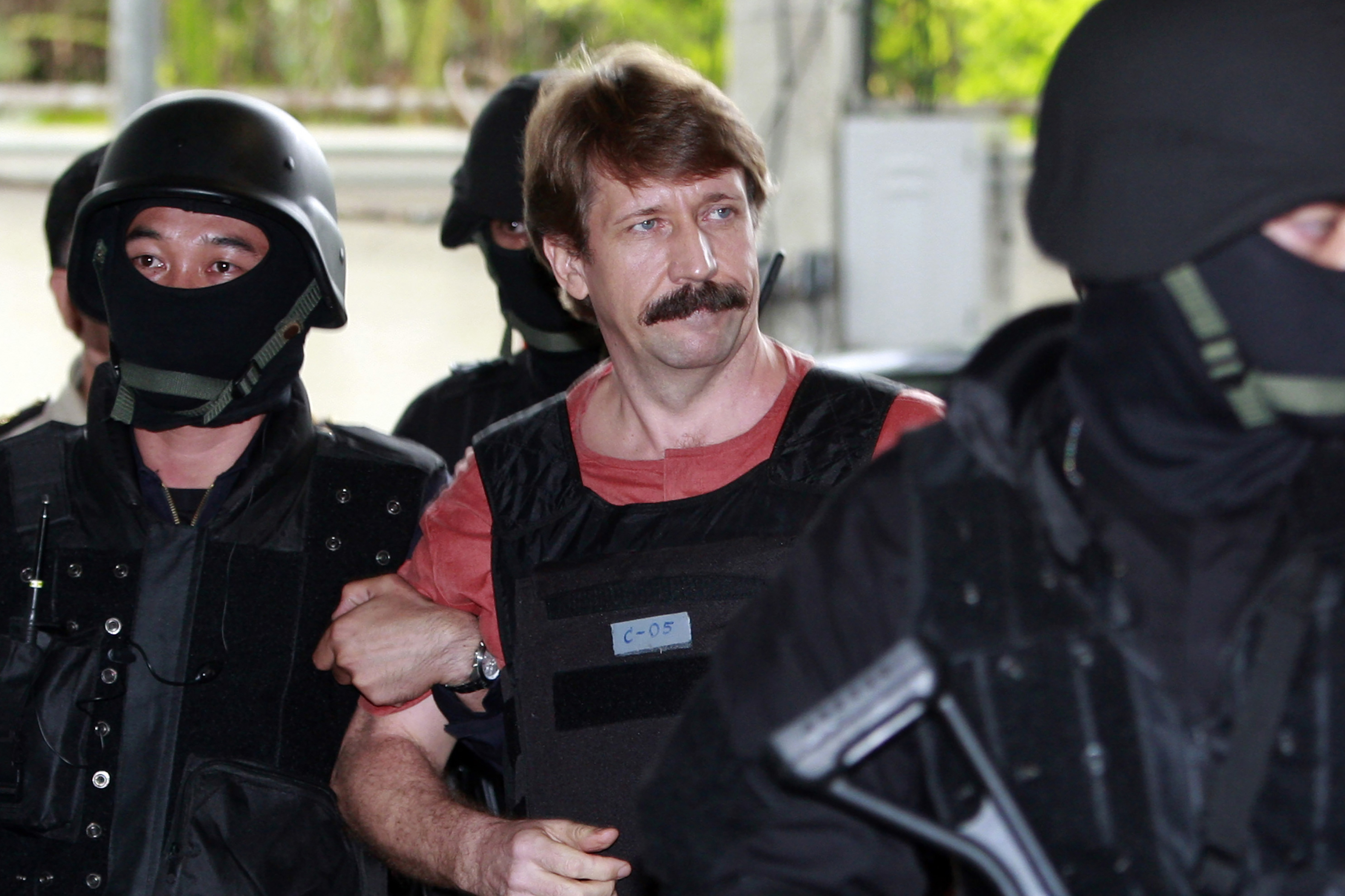 Suspected Russian arms smuggler Viktor Bout, center, is led by armed Thai police commandos as he arrives at the criminal court in Bangkok, Thailand in Oct. 5, 2010. 