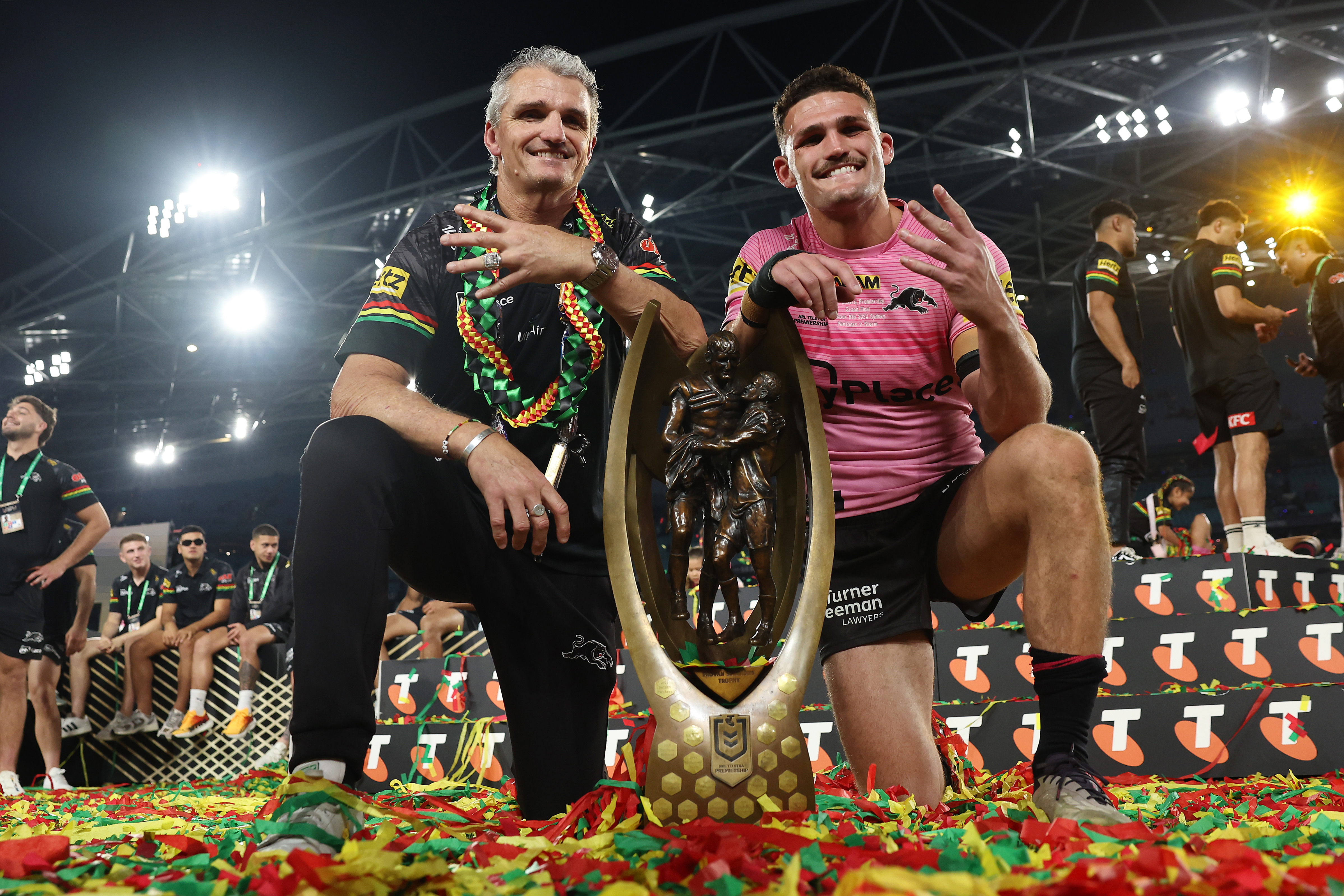 Nathan Cleary (R) of the Panthers poses with the Provan-Summons Trophy alongside his father and coach Ivan Cleary 