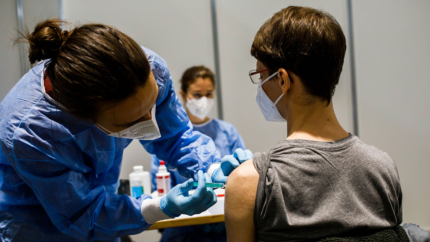 A medical student is vaccinated during a trial in Freiburg, Germany.