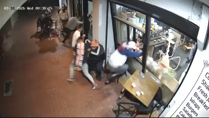CCTV shows the moments the shots were fired and the men run into the building for cover.