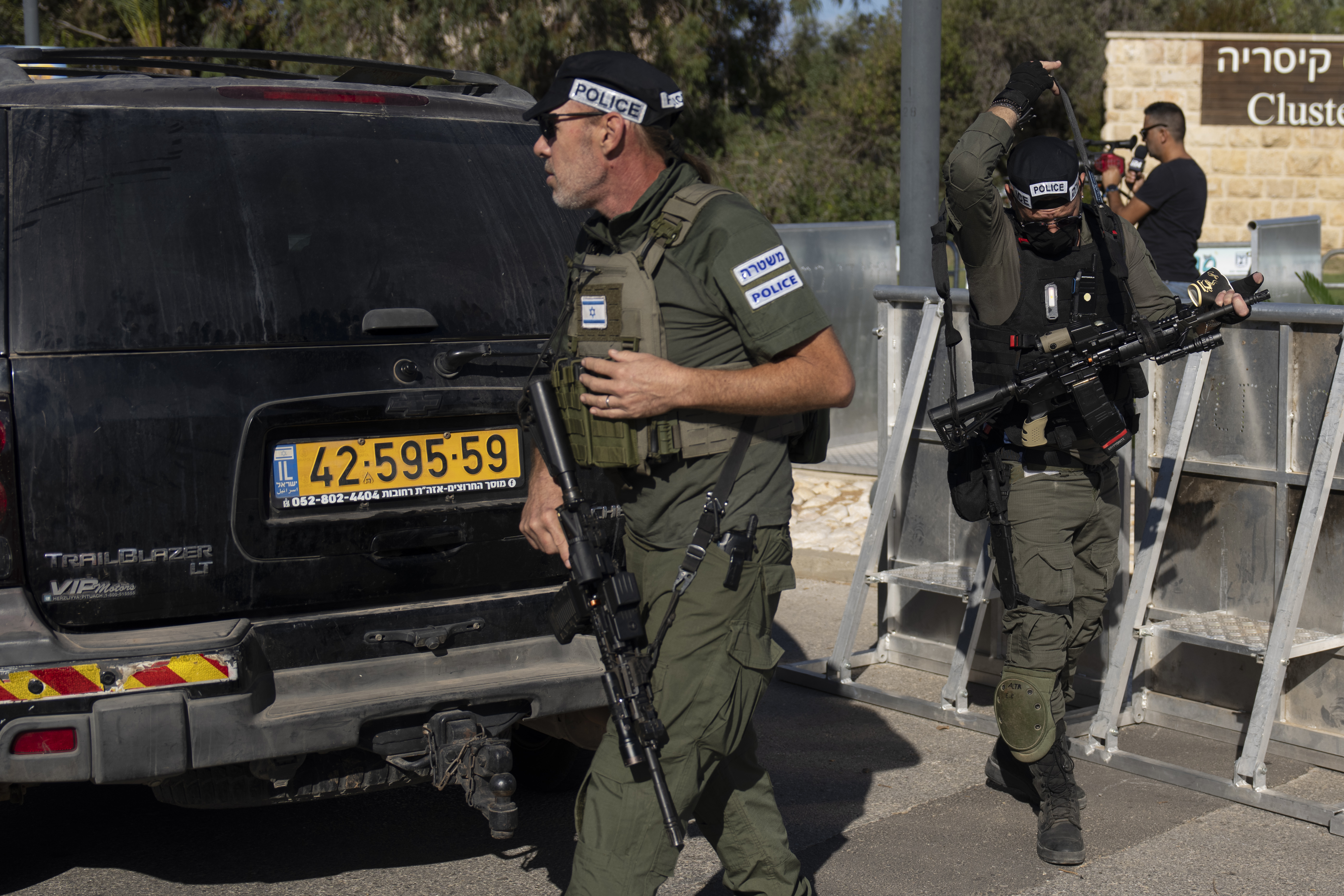 Israeli security forces secure a road near where Israel's government says a drone launched toward Israeli Prime Minister Benjamin Netanyahu's house in Caesarea, Israel Saturday, Oct. 19, 2024. 