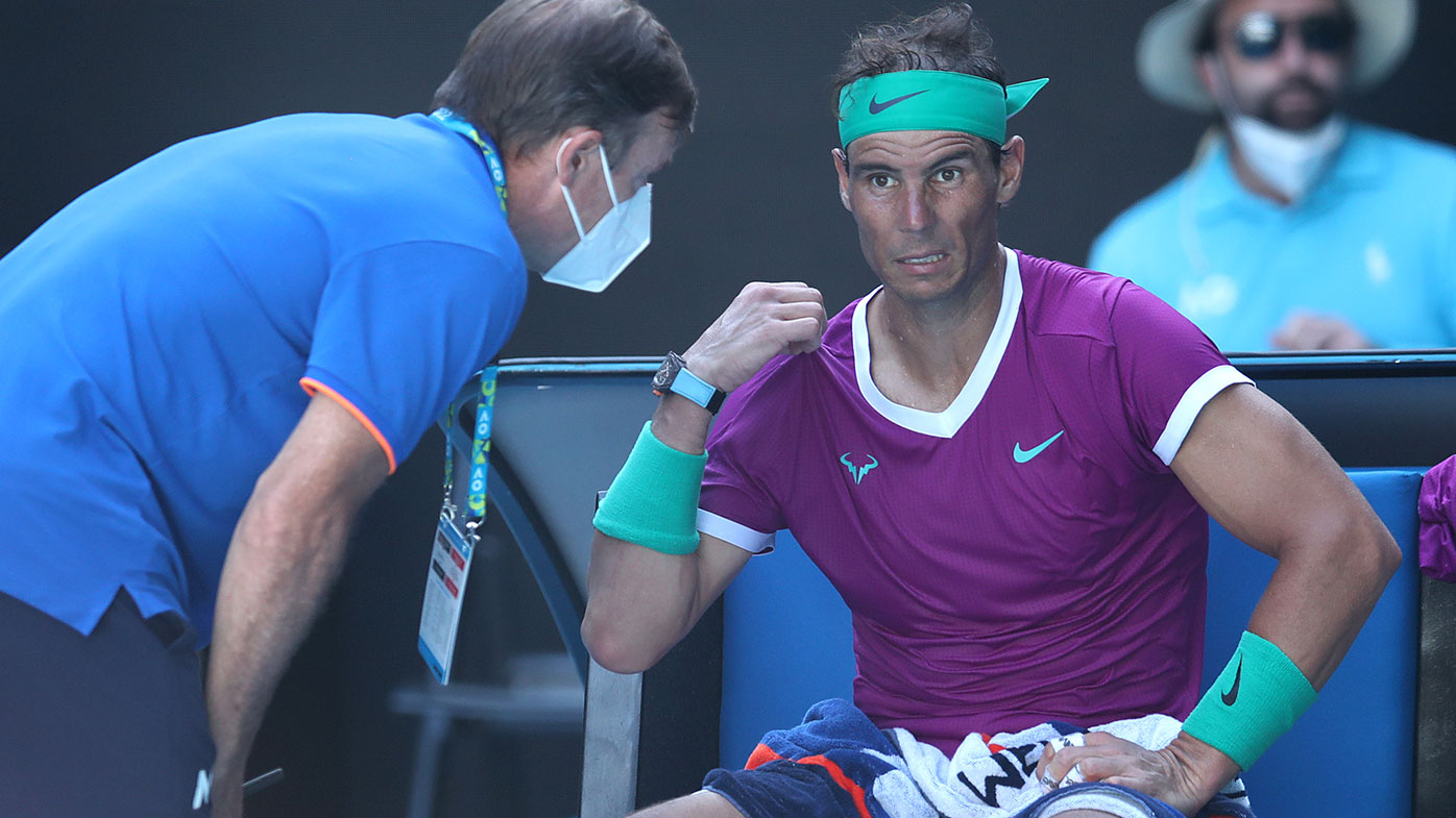 Rafael Nadal of Spain receives attention during a medical time out in his Men's Singles Quarterfinals match against Denis Shapovalov of Canada 