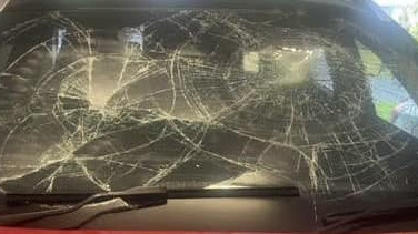 The man smashed the windscreen of the car. 