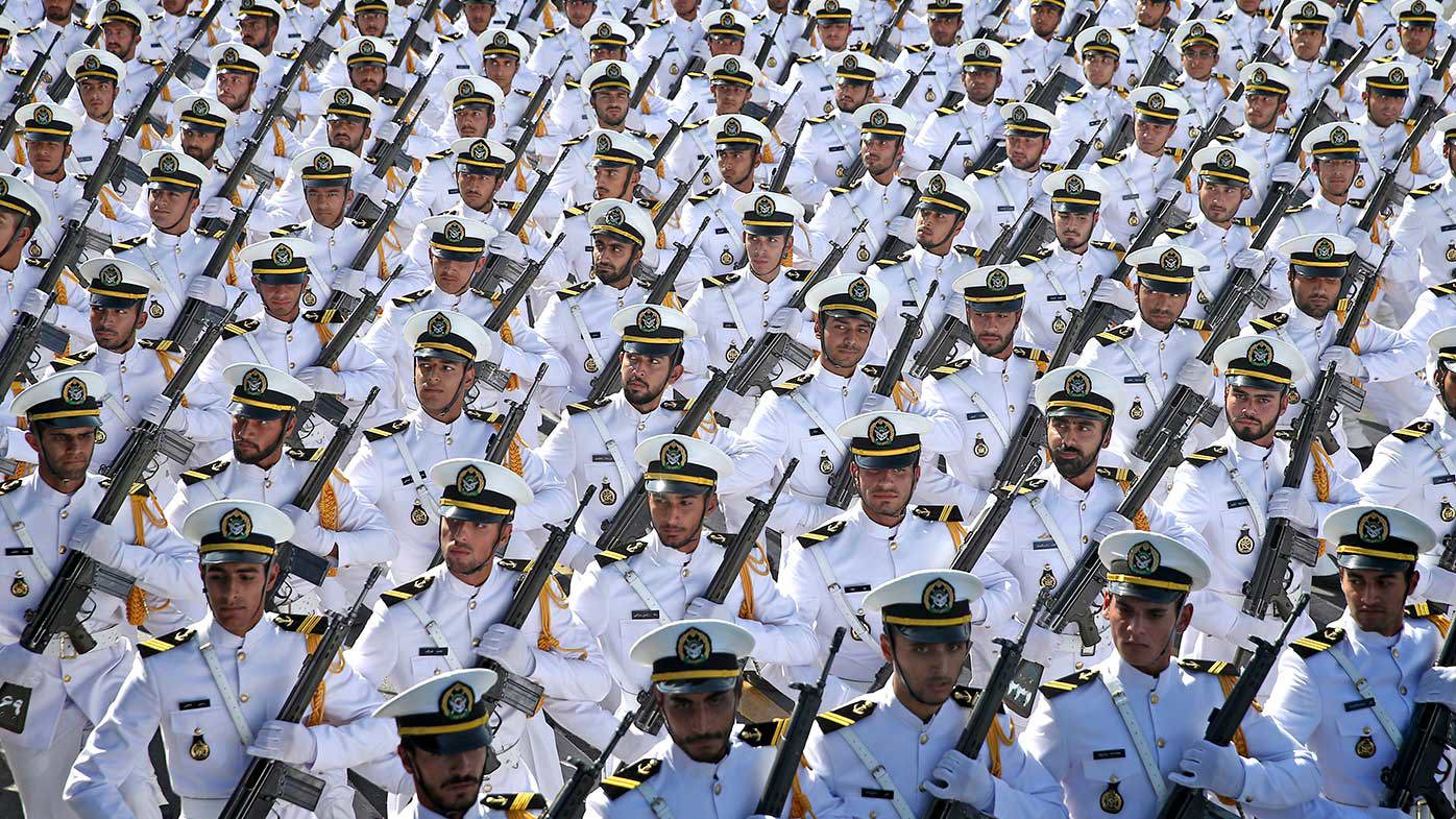 Iranian armed forces members march in a military parade in 2018.