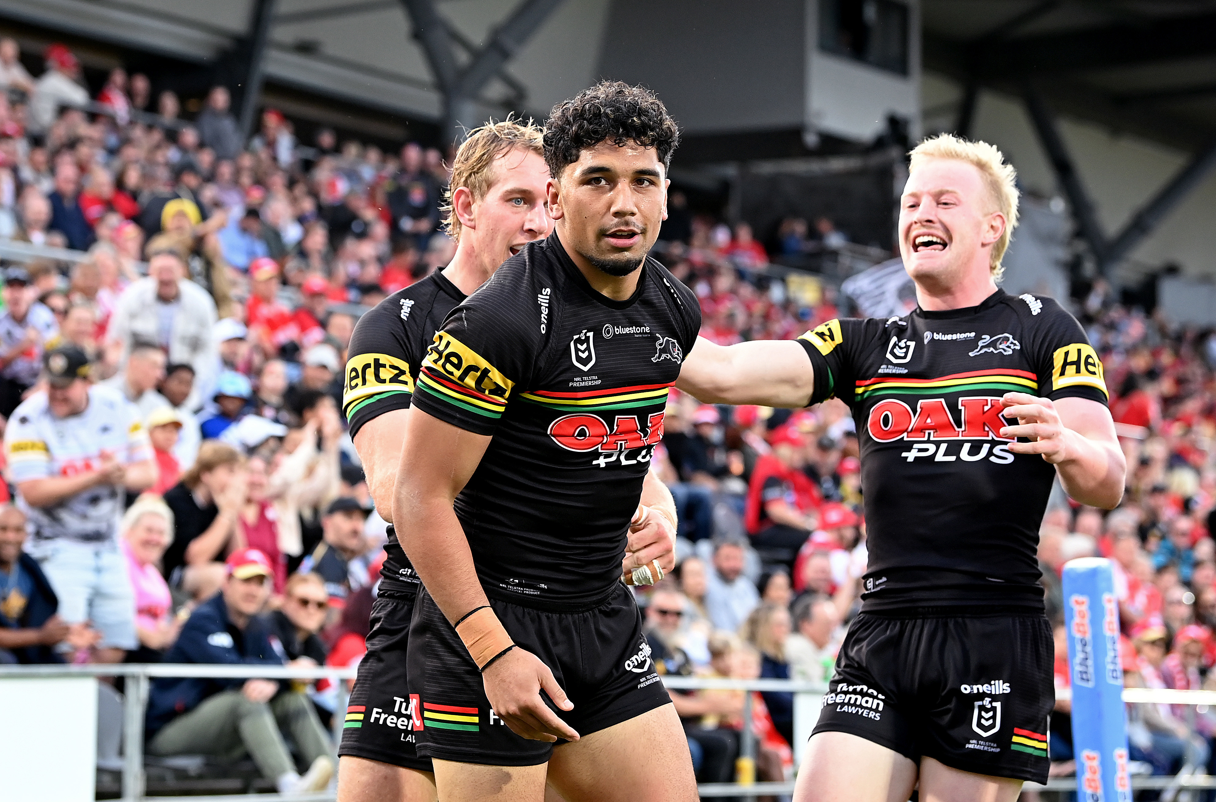 Izack Tago of the Panthers is congratulated by team mates after scoring a try during the round 20 NRL match between the Dolphins and Penrith Panthers at Kayo Stadium on July 16, 2023 in Redcliffe, Australia. (Photo by Bradley Kanaris/Getty Images)