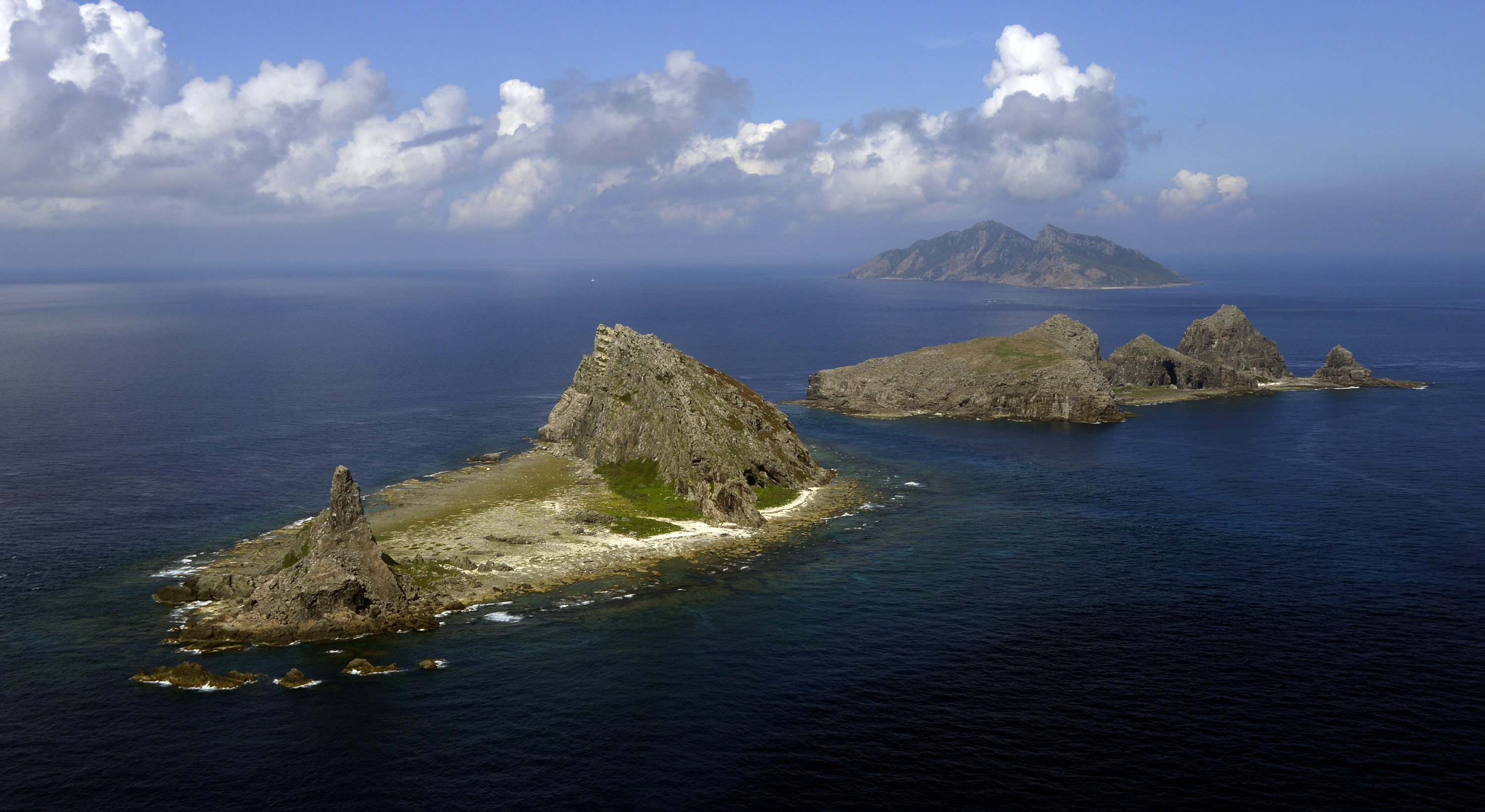 TOKYO, Japan - File photo taken from a Kyodo News airplane shows (from front) Minamikojima, Kitakojima and Uotsuri islands, part of the five main islands in the Senkaku group in the East China Sea, on Sept. 11, 2013, a year after the Japanese government purchased the three islands, which are also claimed by China and Taiwan. (Photo by Kyodo News Stills via Getty Images)