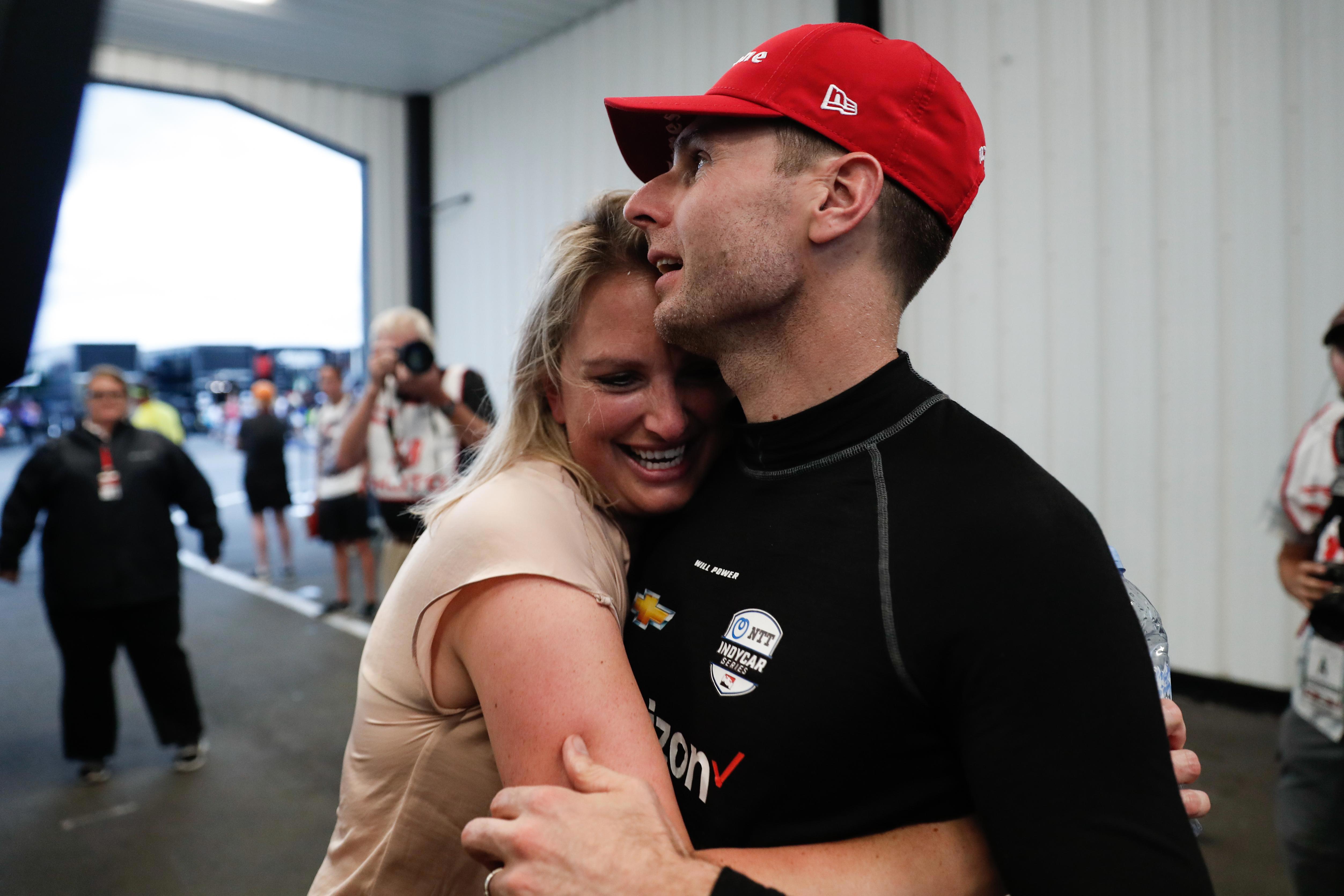 Liz Power (left) celebrates with husband Will after winning the 2019 IndyCar race at Pocono.