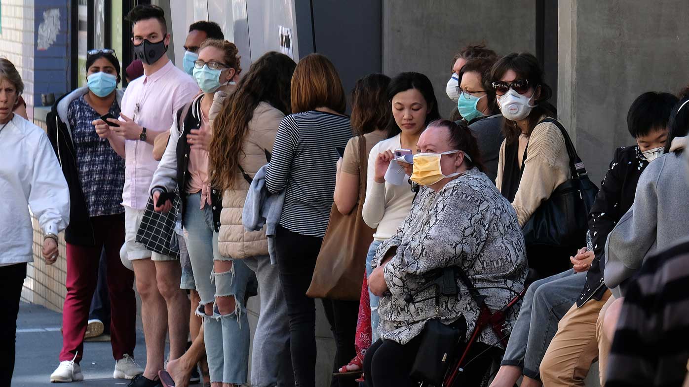 People are seen lining up to get tested for Coronavirus at the Royal Melbourne Hospital on Tuesday 10 March 2020