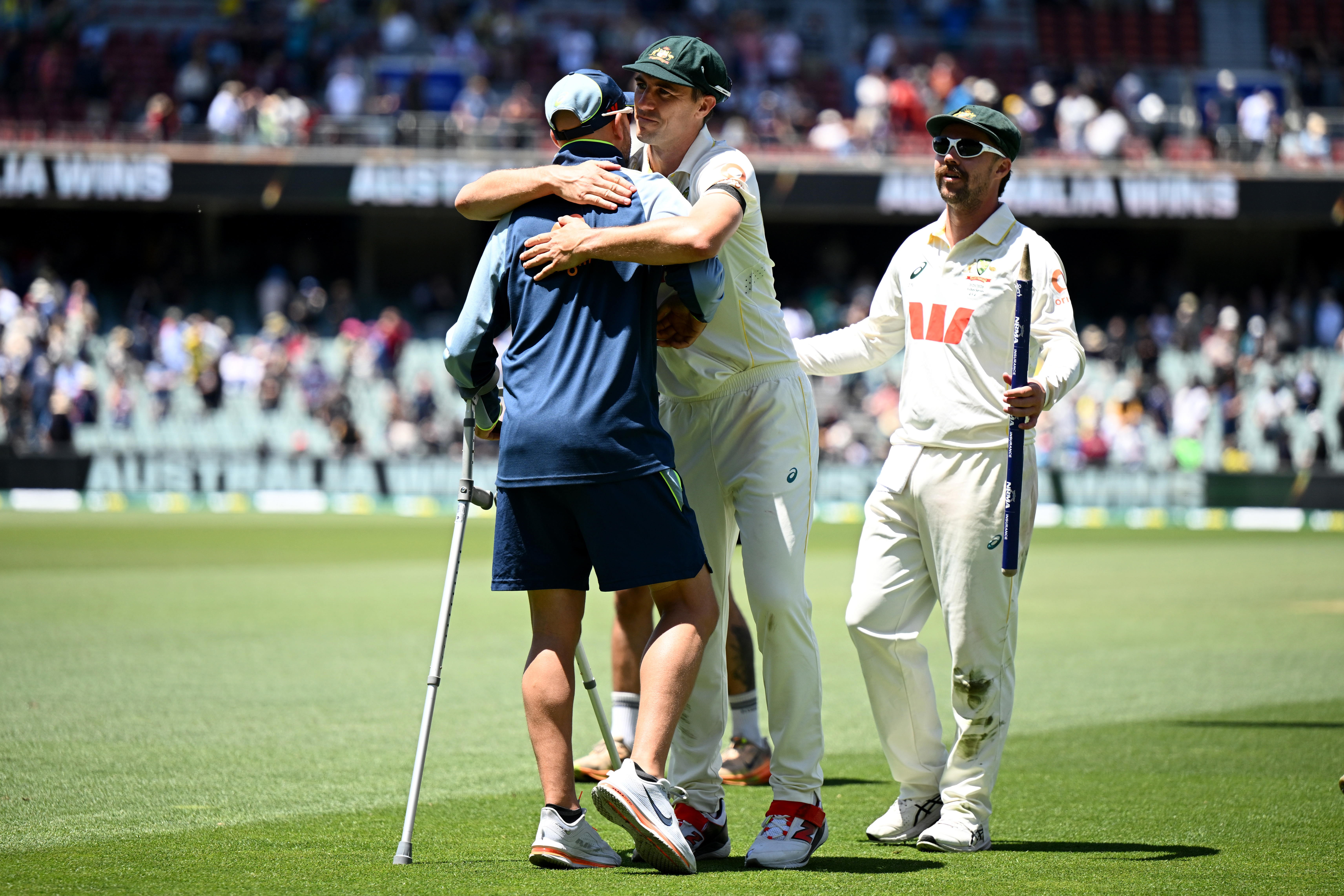 Pat Cummins embraces Nathan Lyon after securing victory in the third Test at the Adelaide Oval.