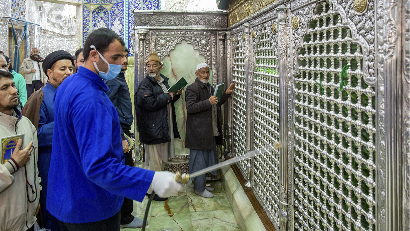 In this Monday, Feb. 24, 2020, photo, a man disinfects the shrine of Saint Masoumeh against coronavirus in the city of Qom 78 miles (125 kilometers) south of the capital Tehran, Iran